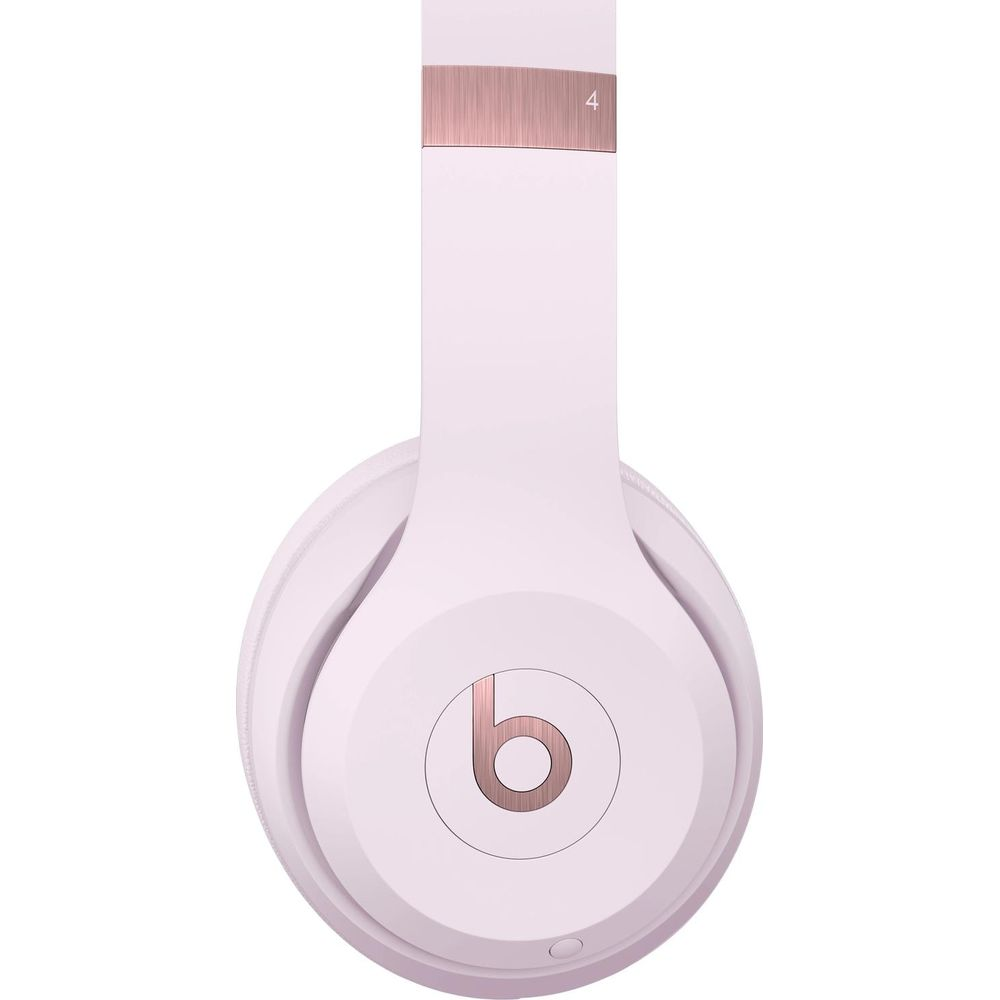 Białe słuchawki z różowo-złotymi akcentami i logo "b".