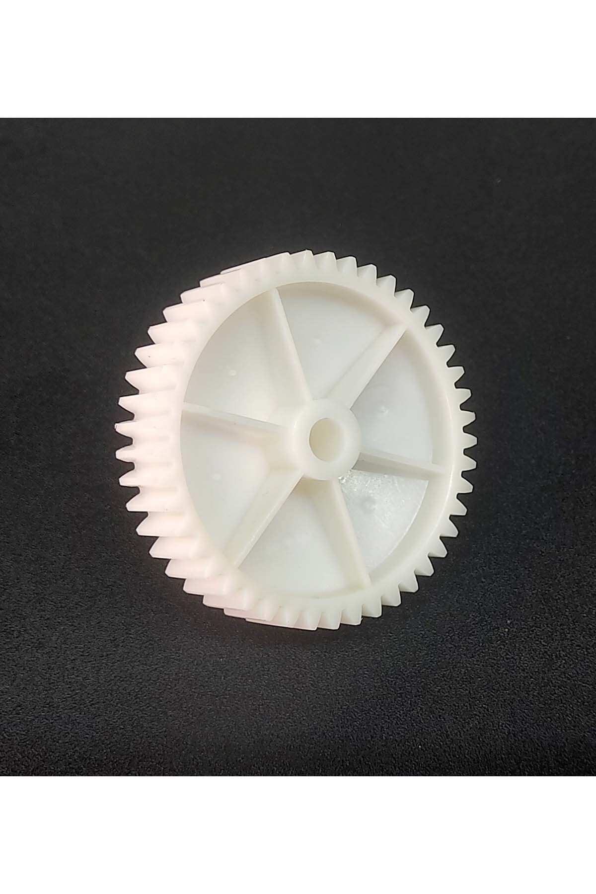 Siyah arka plan üzerinde altı kollu beyaz plastik dişli.