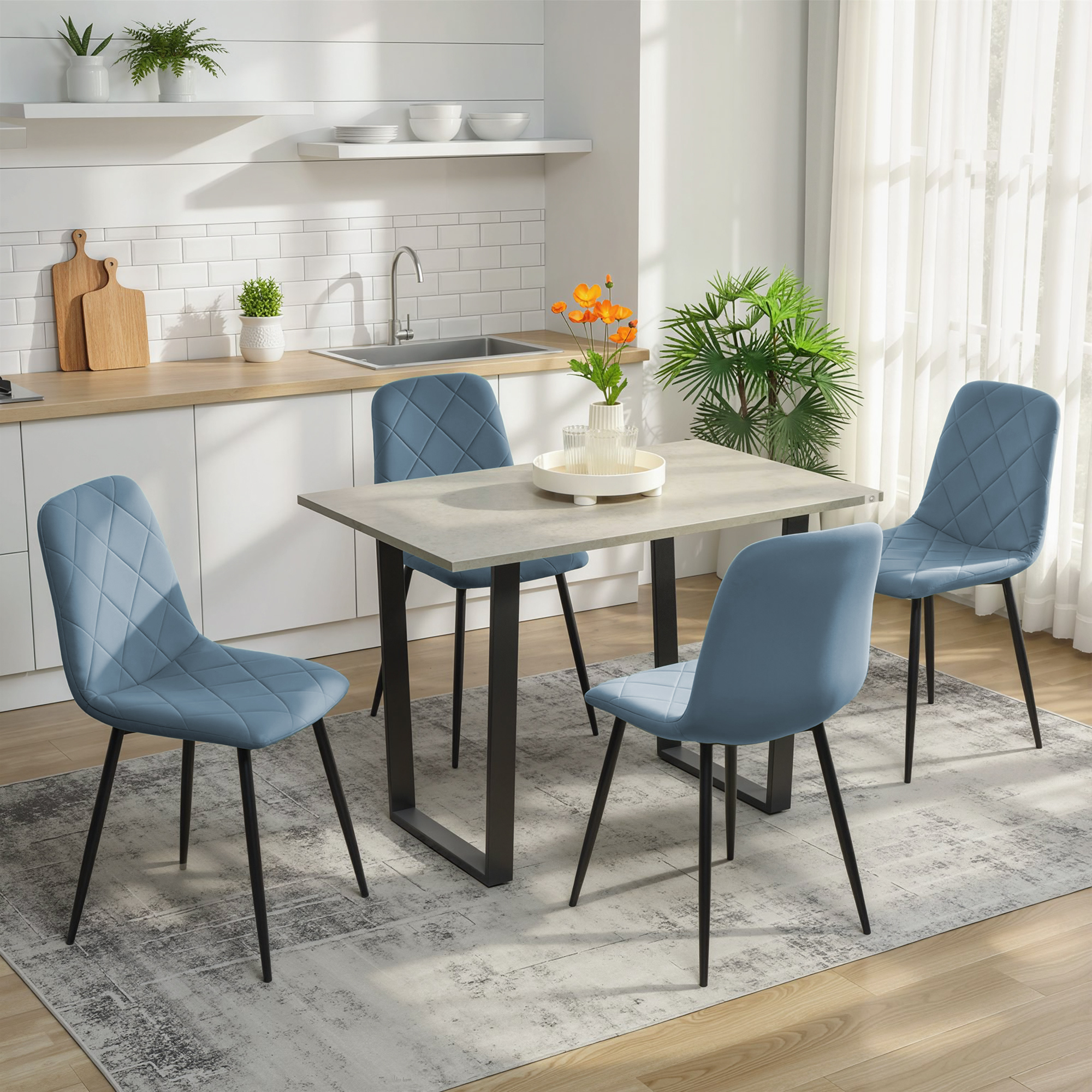 Una mesa de comedor con cuatro sillas azules en una cocina con encimera y fregadero.