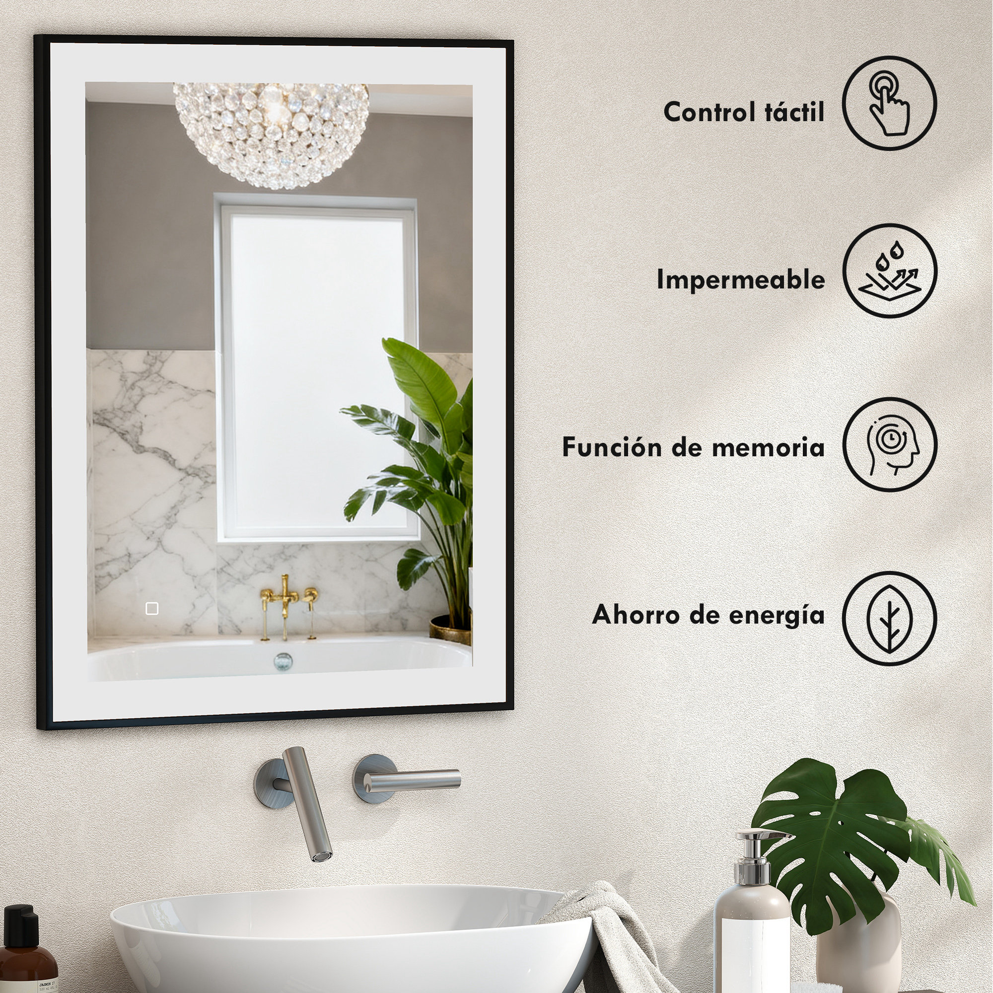 Un espejo con candelabro de cristal sobre una bañera, con un grifo cerca.