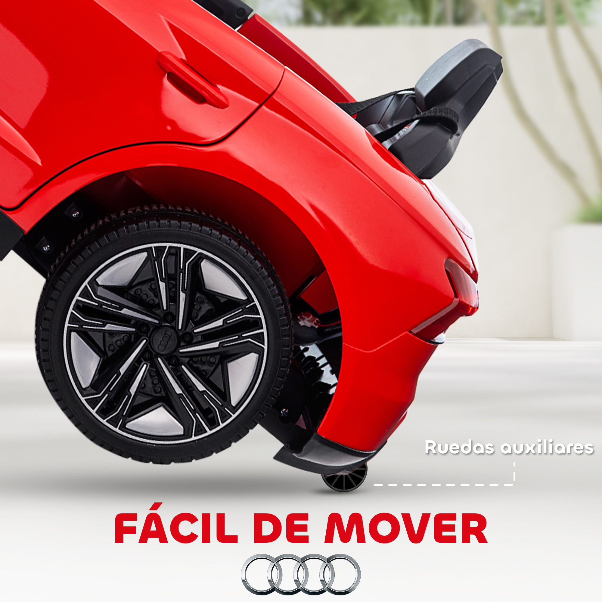 Parte trasera de coche de juguete rojo con rueda negra y ruedas auxiliares.