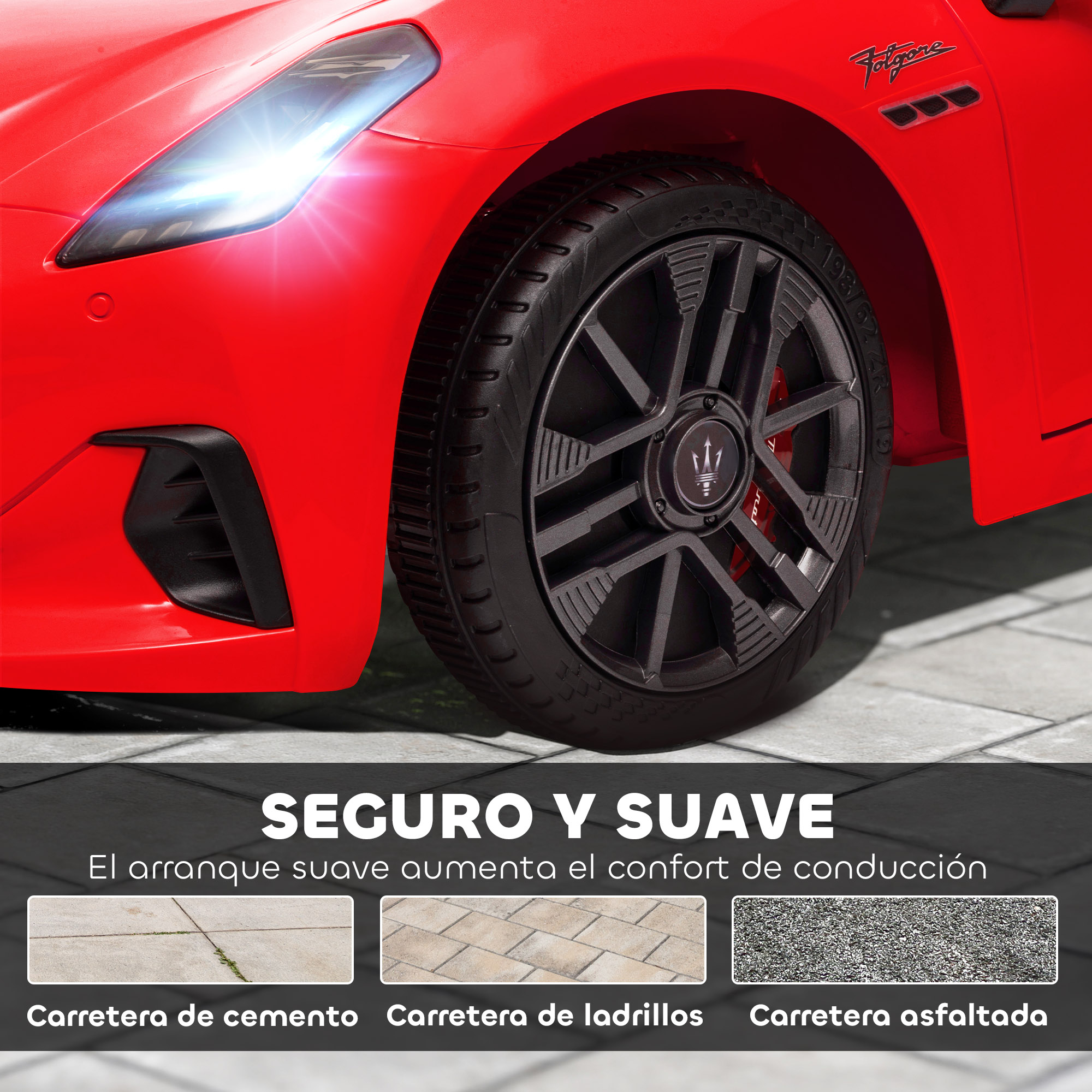 Coche deportivo rojo con faro iluminado y rueda sobre pavimento.