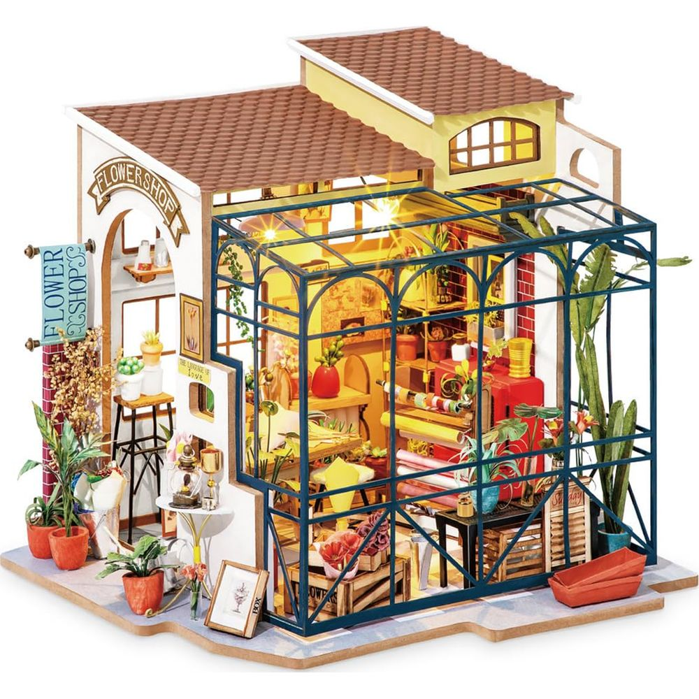 Tienda de flores en miniatura con invernadero, plantas, flores y decoraciones.