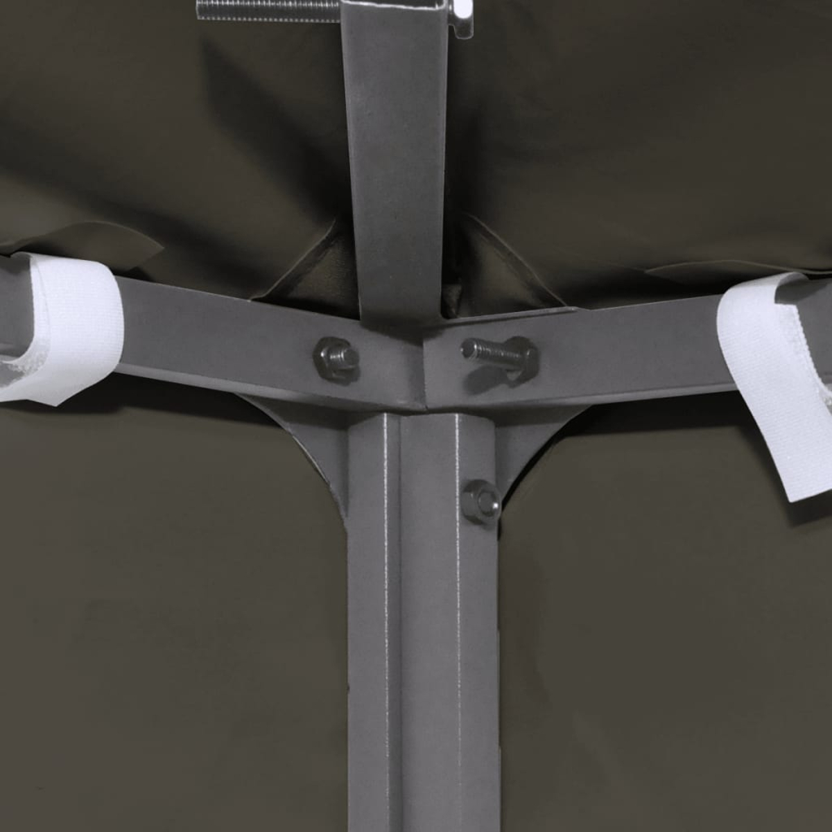 Puntali metallici grigi con bulloni e cinghie in velcro bianche sotto una tettoia scura.