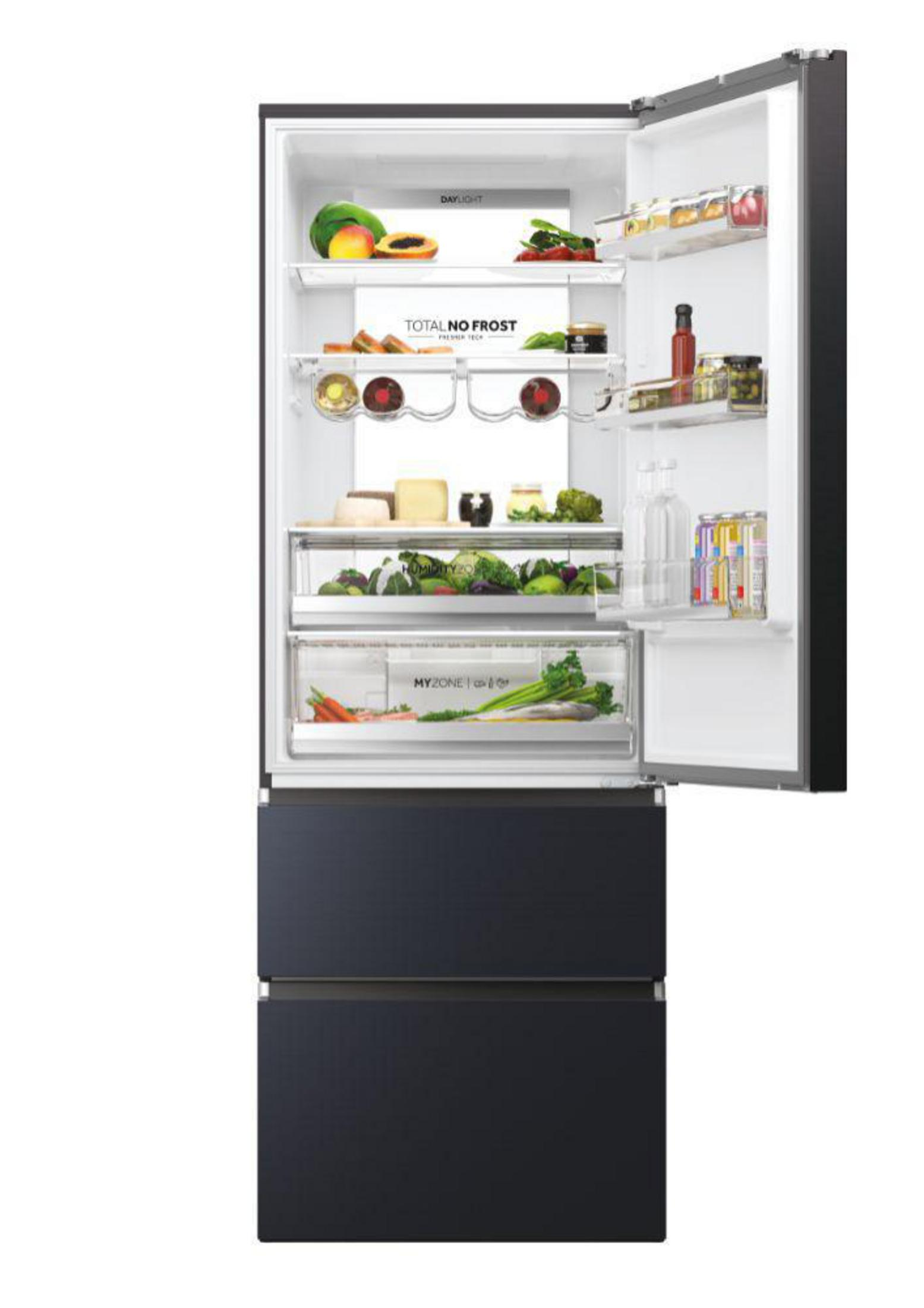 Un refrigerador abierto lleno de frutas, verduras, botellas y latas.