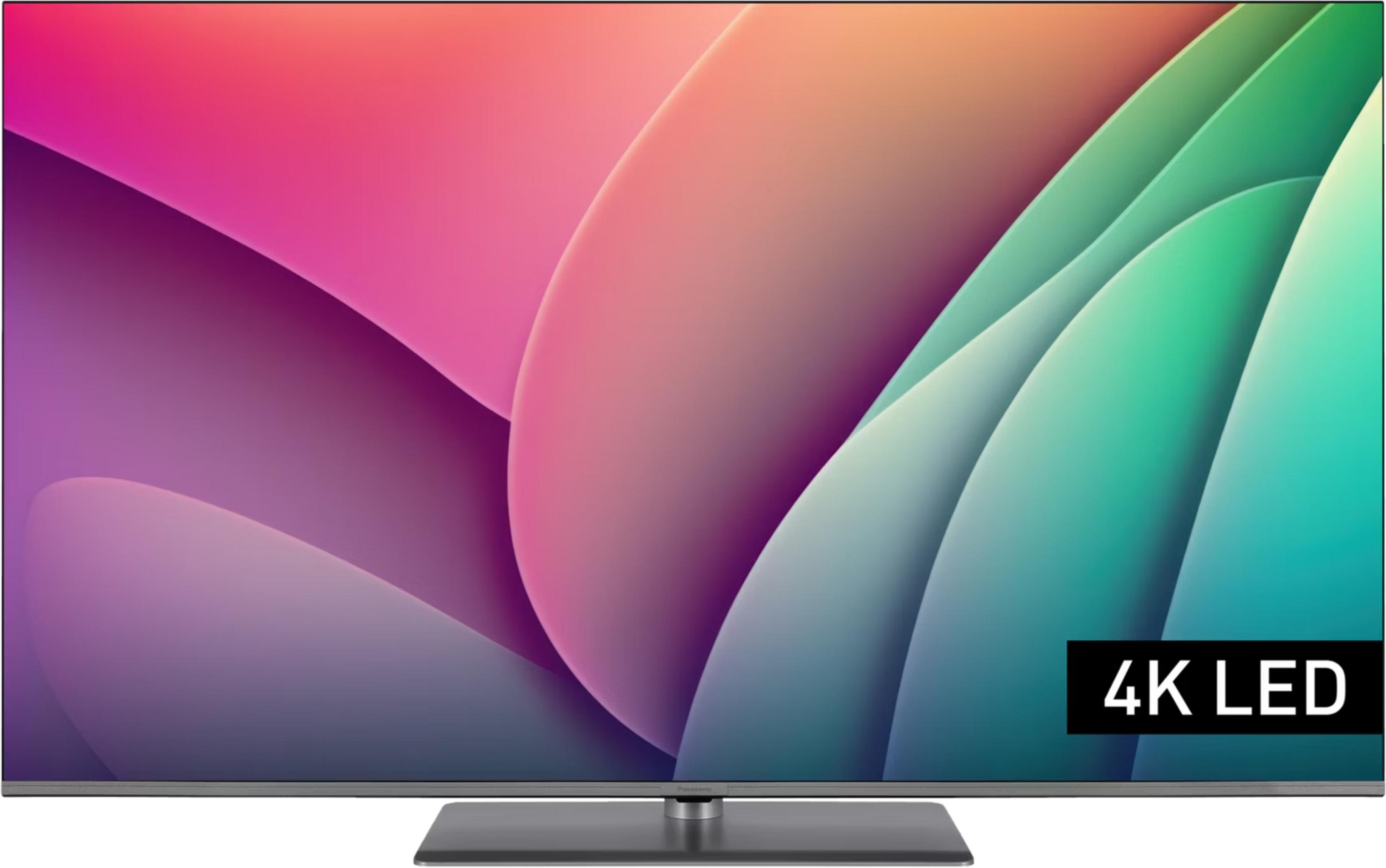 Un televisor moderno de pantalla plana que muestra 4K LED en un fondo abstracto.