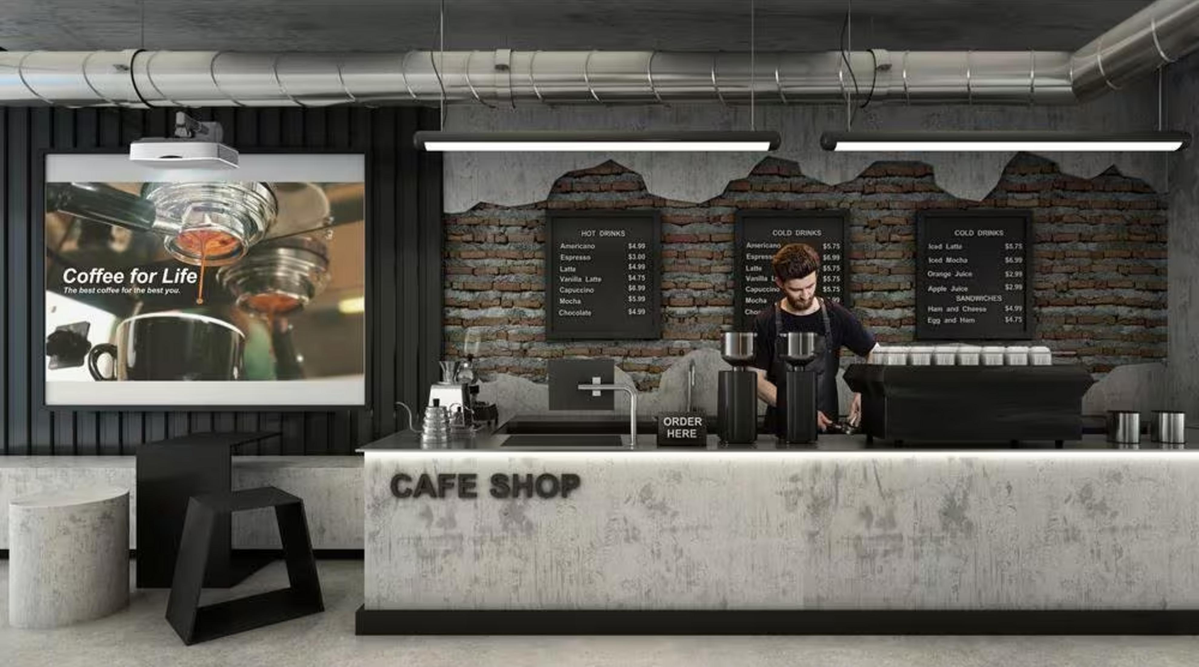 Mężczyzna stoi za ladą kawiarni, obsługując klientów. Menu wiszą na ścianie.