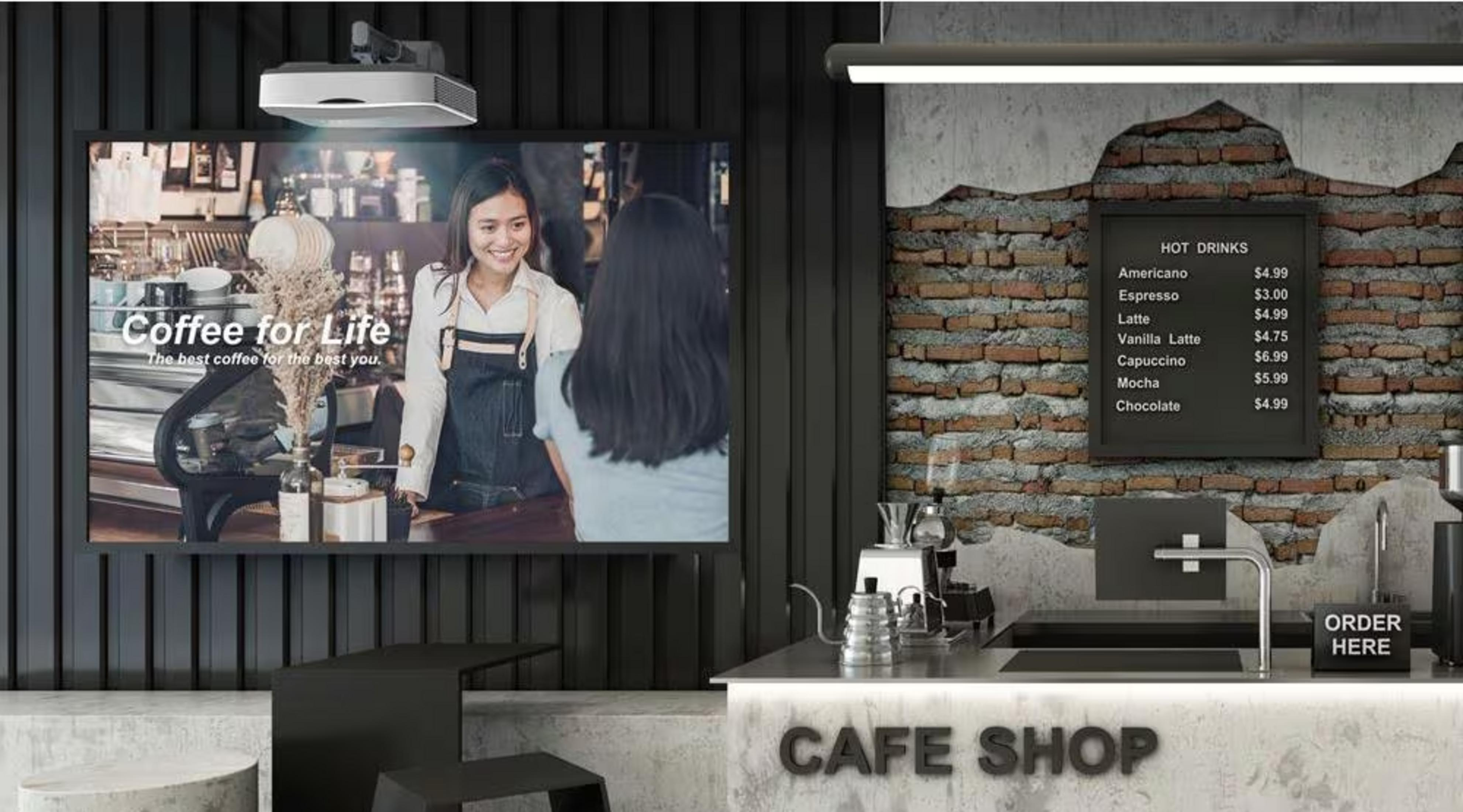 Kawiarnia z cyfrowym wyświetlaczem pokazującym kawę. Menu wisi na ścianie.