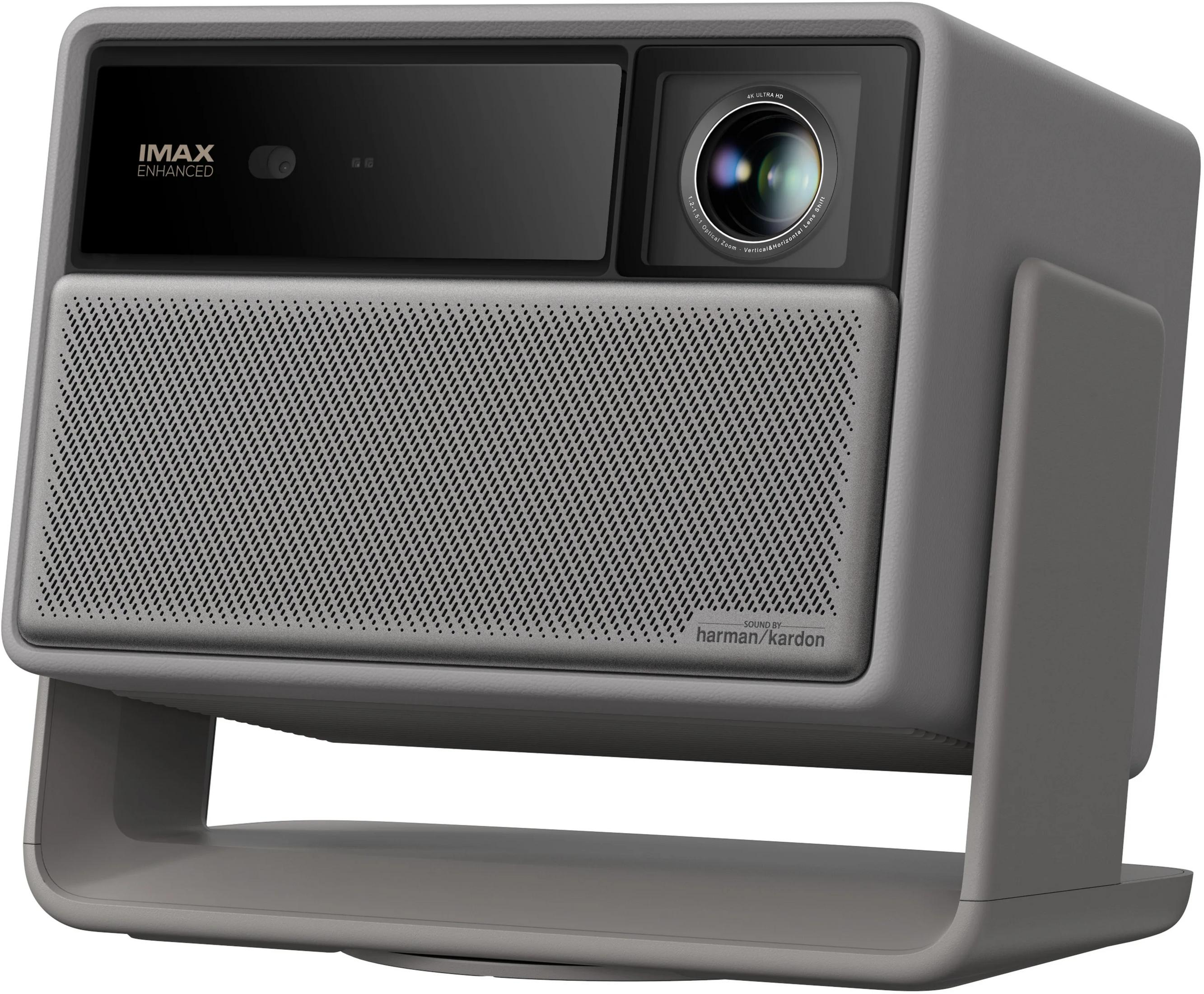 A gray projector with IMAX Enhanced logo, lens, and Harman Kardon logo.