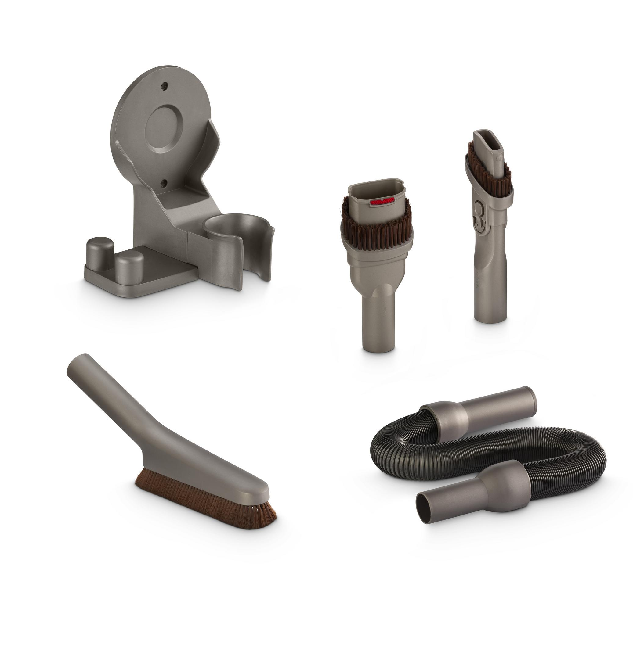 Accessori grigi per aspirapolvere: supporto a muro, spazzole e tubo.
