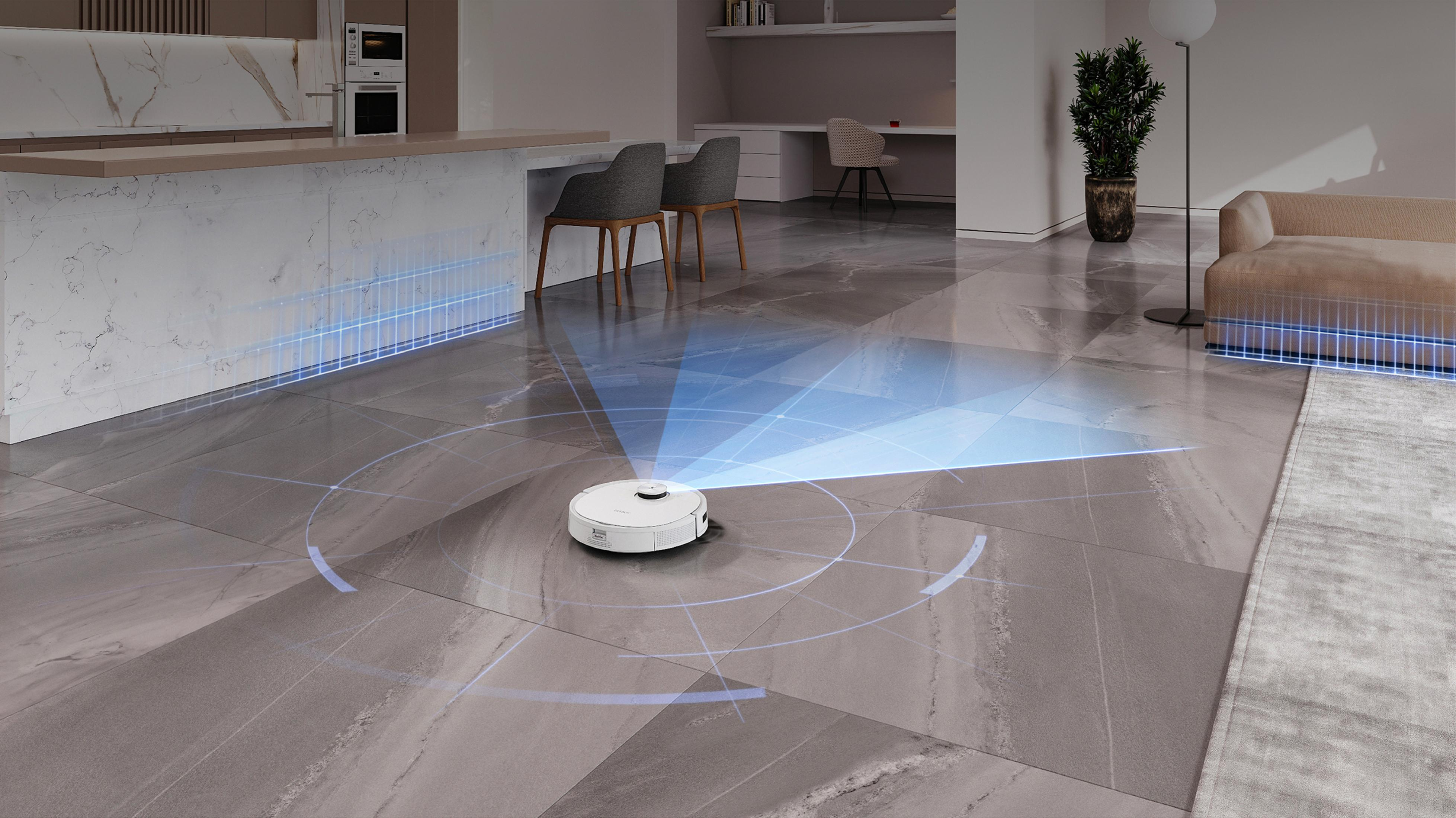 Un robot aspirateur blanc fonctionne dans un espace de vie moderne aux sols carrelés gris.