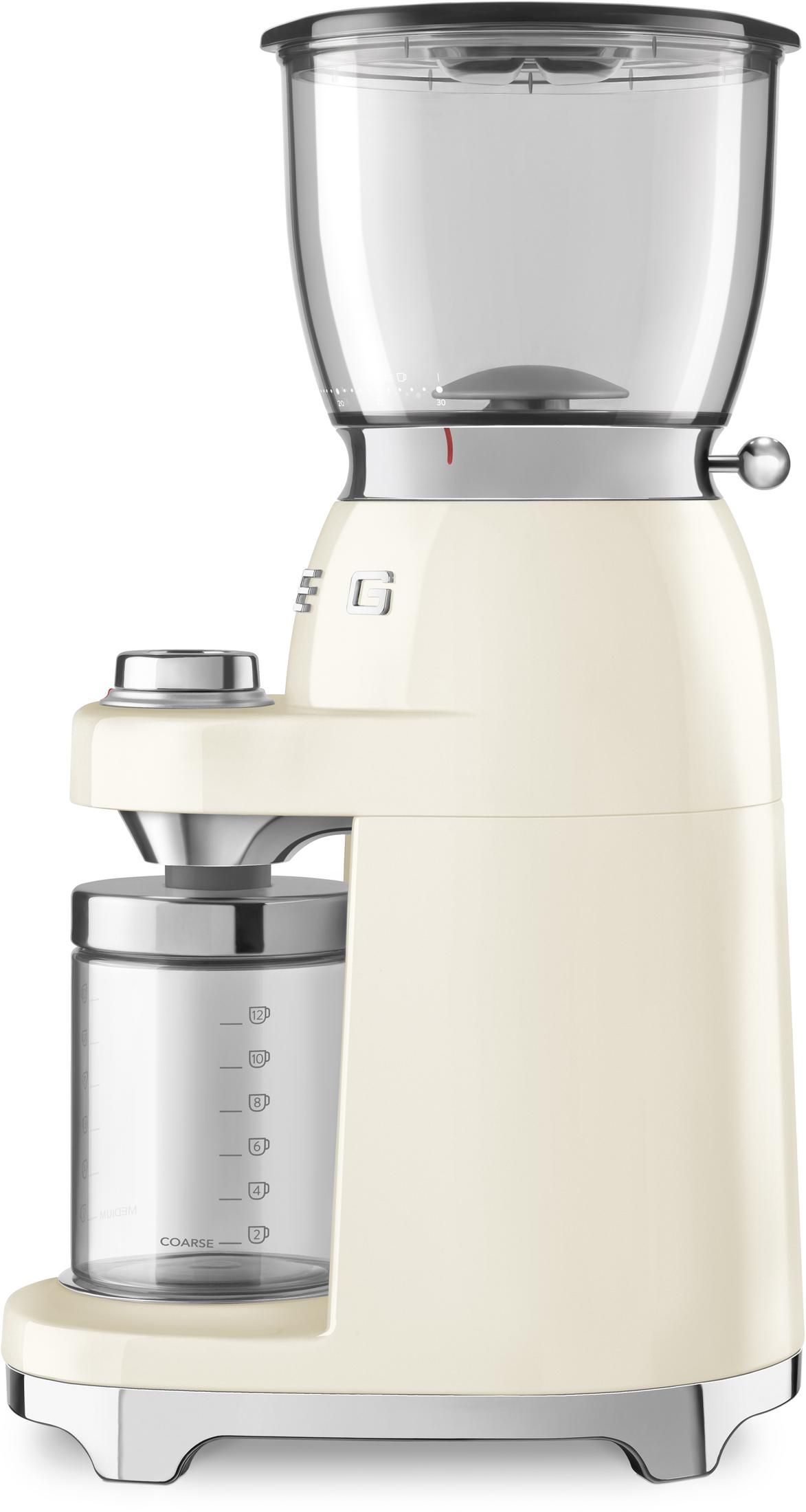 Kremowy młynek do kawy z srebrnymi akcentami i szklanym pojemnikiem.