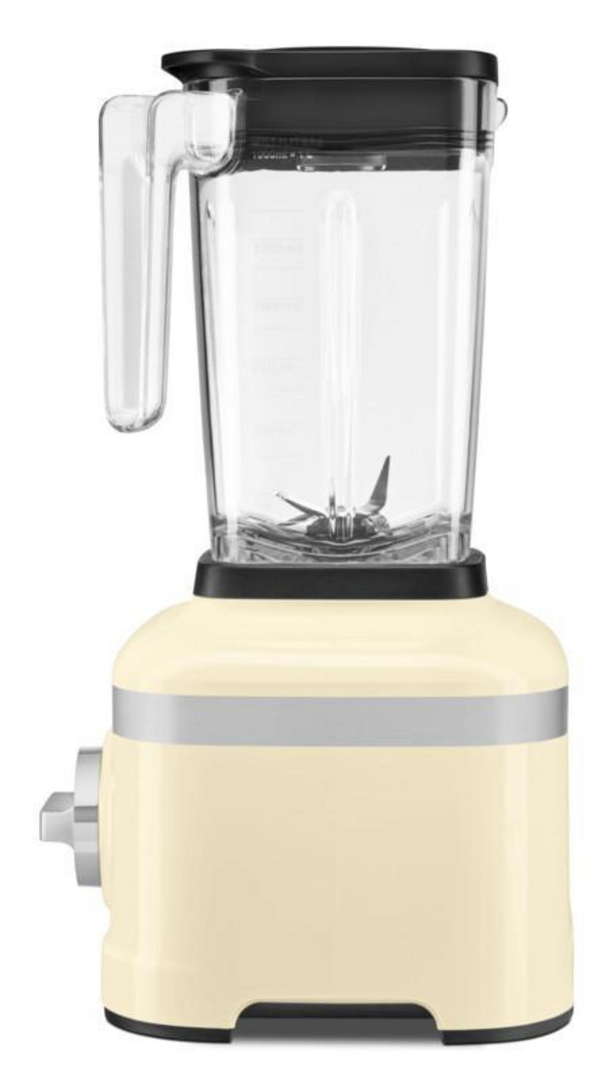 A cream-colored blender with a black lid and glass jar with silver accents.