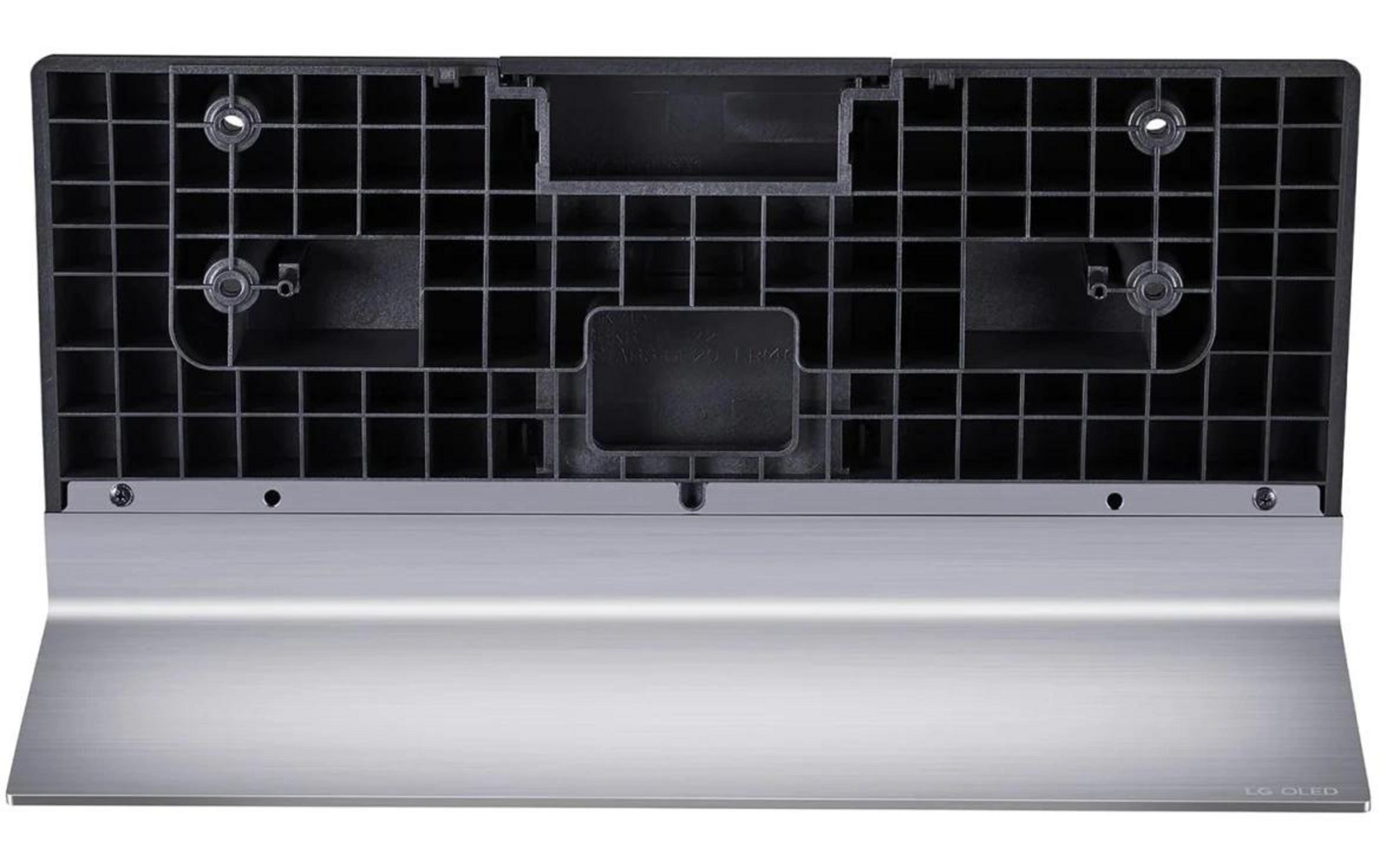 Parte trasera de un soporte de TV negro de plástico con base plateada.