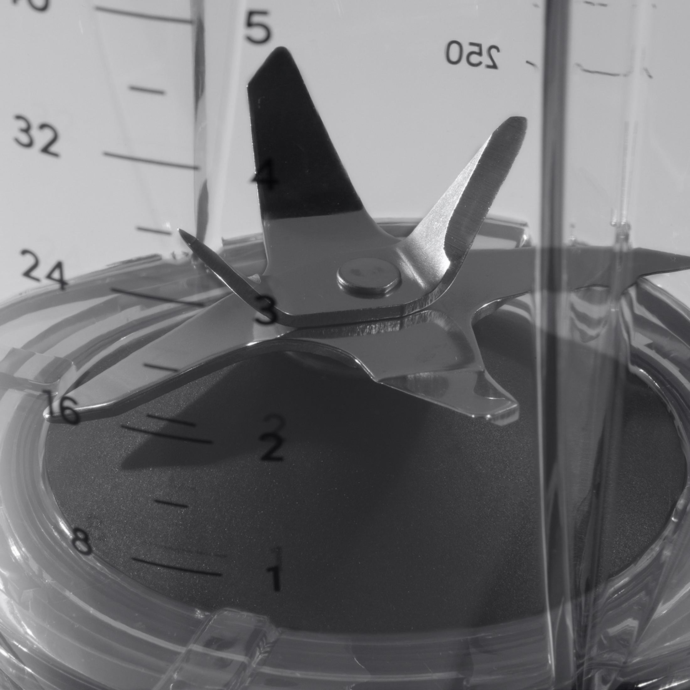 Zbliżenie ostrzy blendera z miarką na pojemniku.