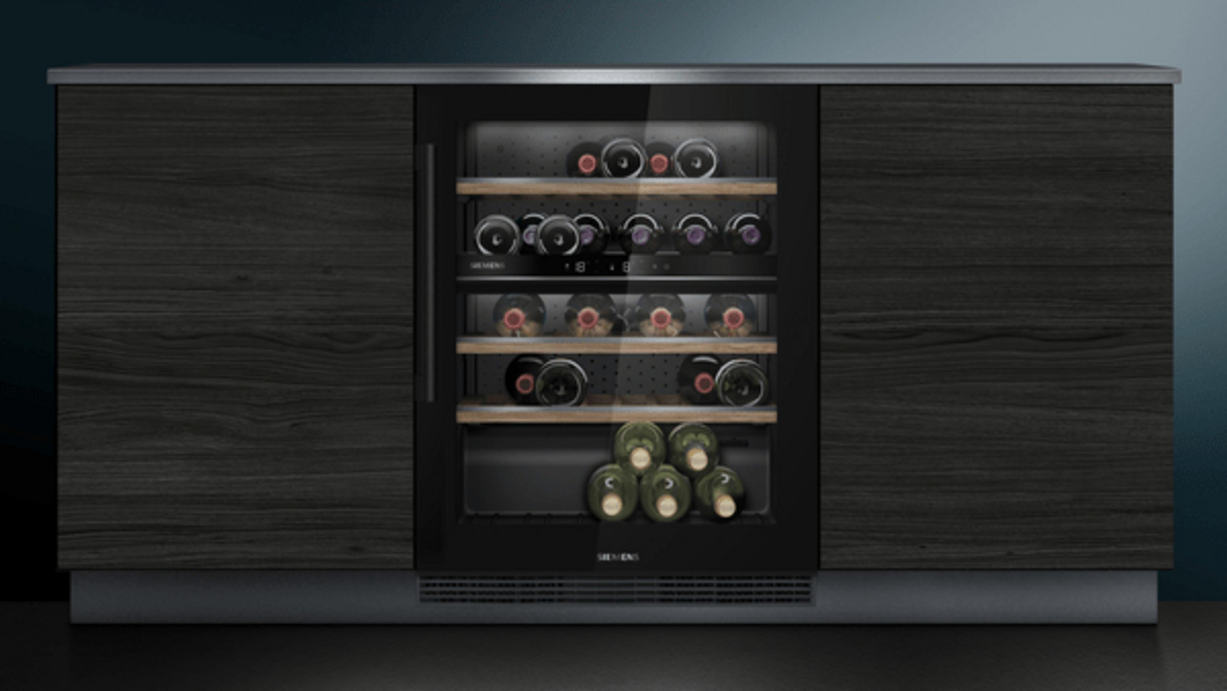 A wine fridge with dark wood elements and a glass front, filled with bottles.