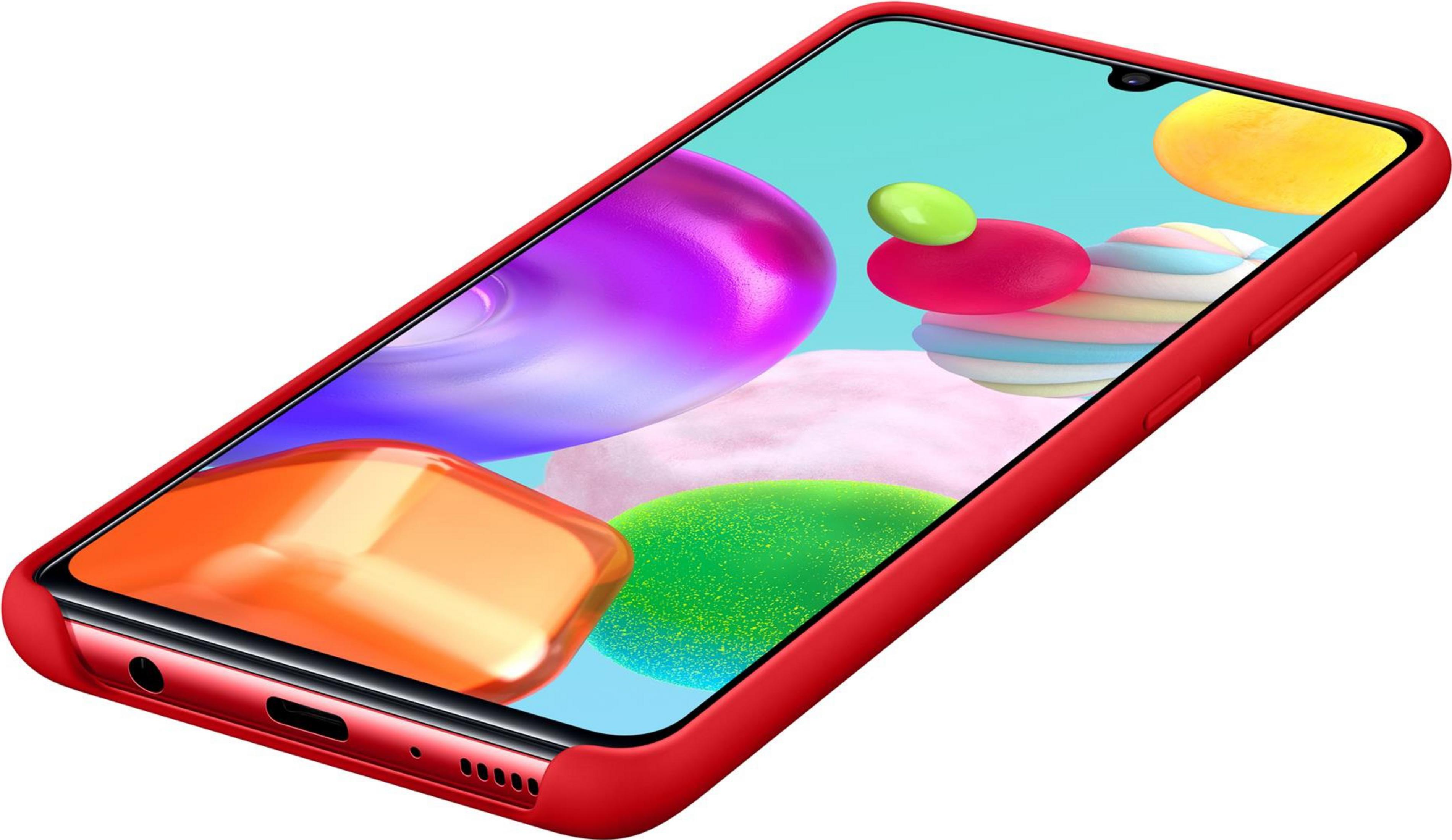 Uno smartphone rosso con sfondo colorato e forme astratte.