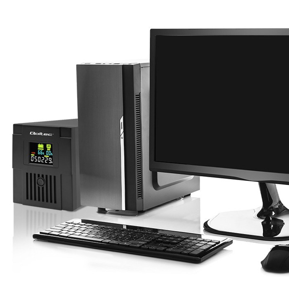 Czarny monitor komputerowy, smukły komputer, zasilacz awaryjny i klawiatura na białej powierzchni.