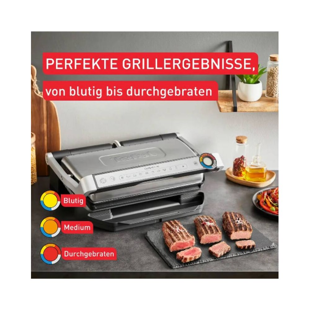 Grill kontaktowy Tefal z trzema grillowanymi stekami na desce łupkowej.