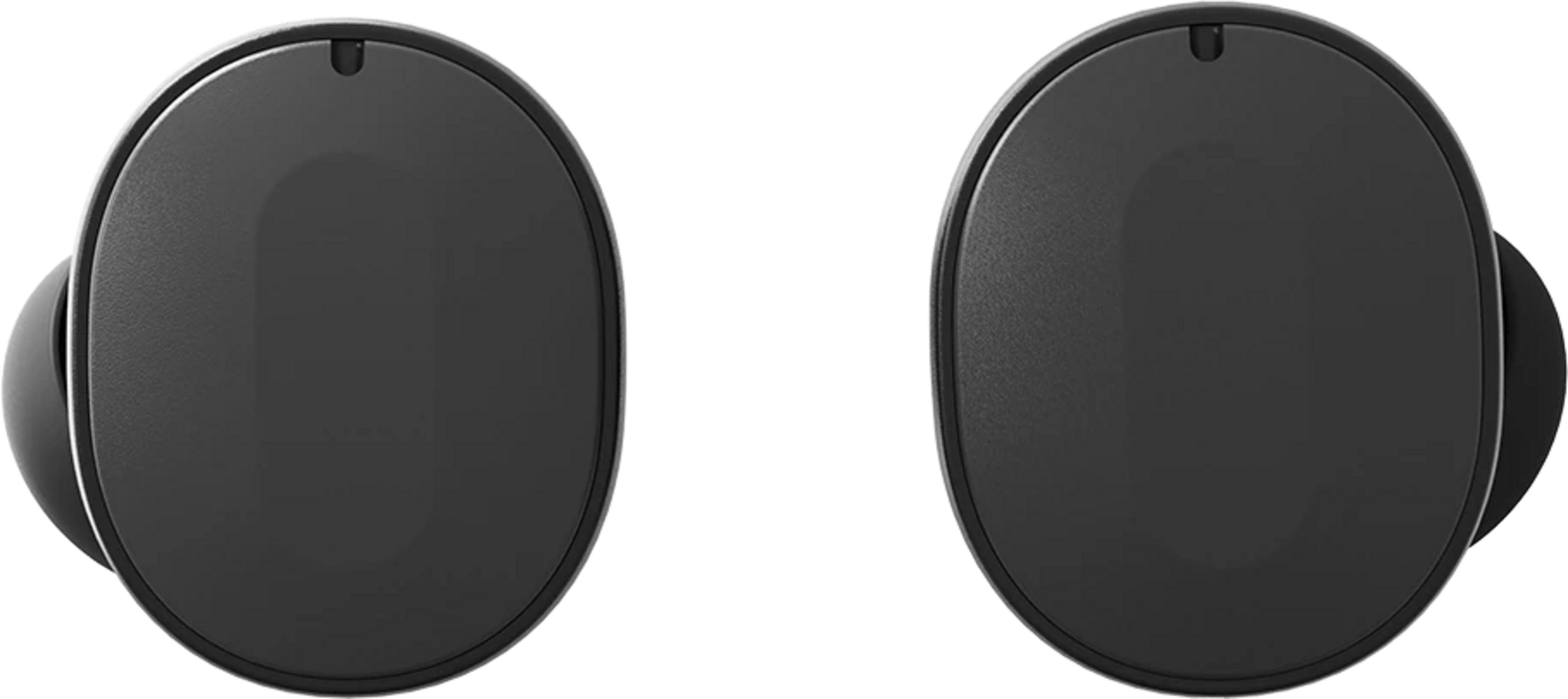 Dwa czarne, owalne słuchawki na białym tle.