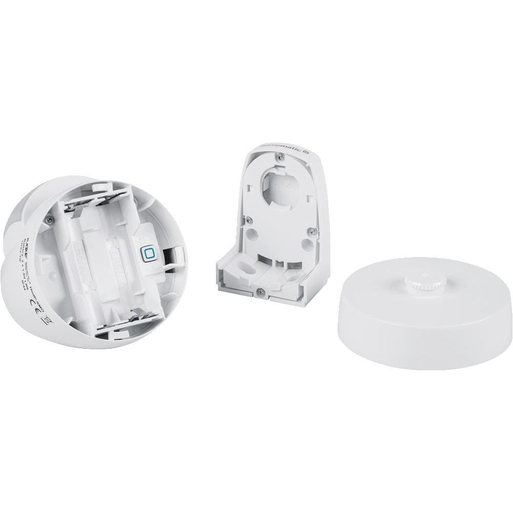 Białe komponenty elektroniczne: komora baterii, wspornik i pokrywa.