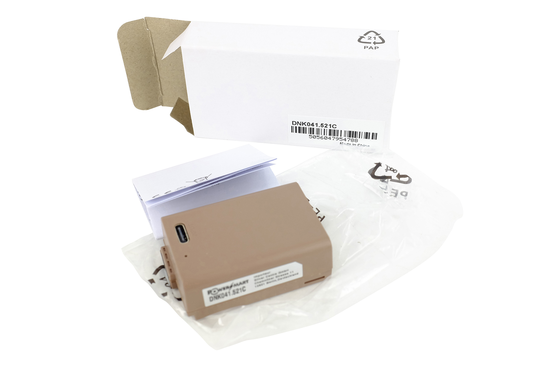 Eine braune Batteriepackung mit Zubehör und offener weißer Box auf weißem Hintergrund.