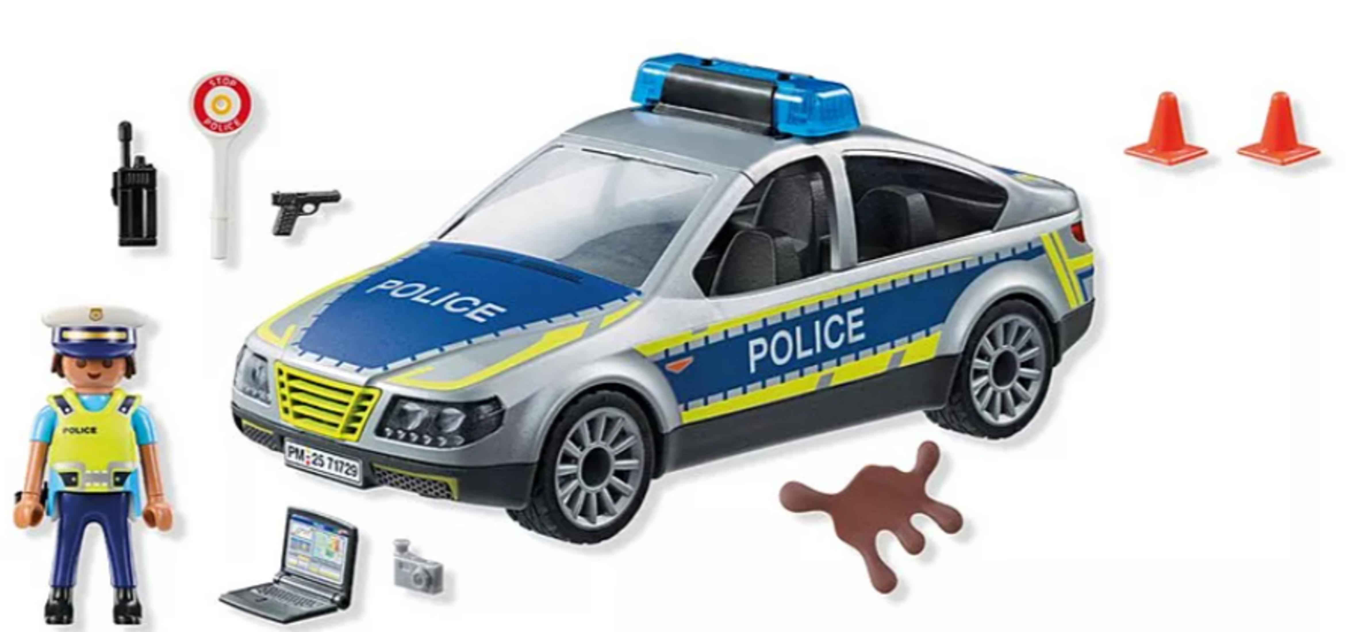 Samochód policyjny z akcesoriami: policjant, radio, znak stop, pistolet, laptop, aparat, pachołki.