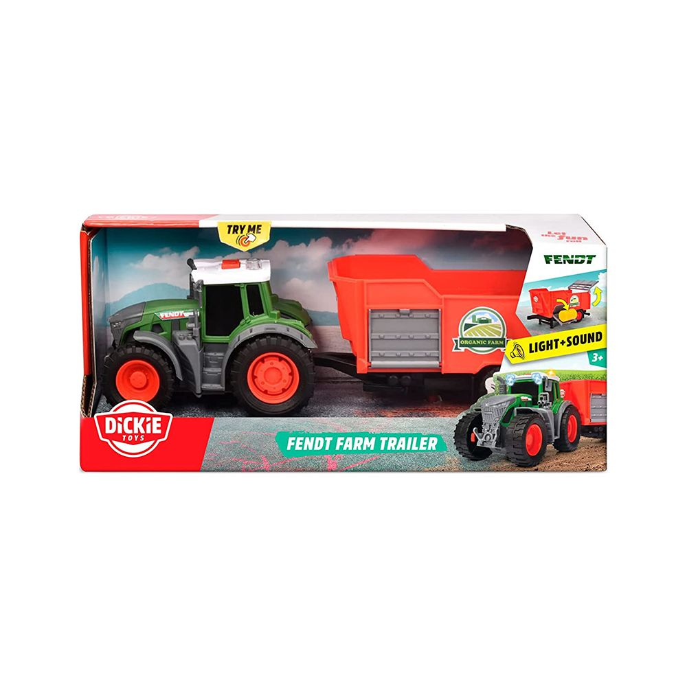 Grüner Spielzeugtraktor mit rotem Anhänger in der Verpackung.