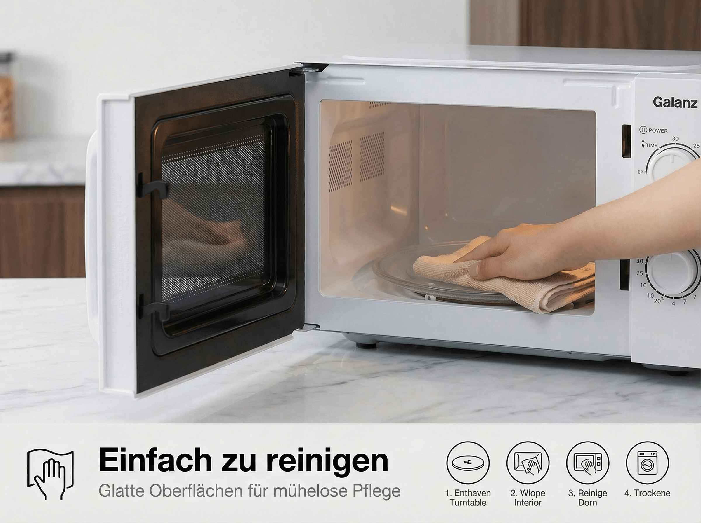 Eine Hand reinigt mit Tuch den Drehteller in einer Galanz Mikrowelle.