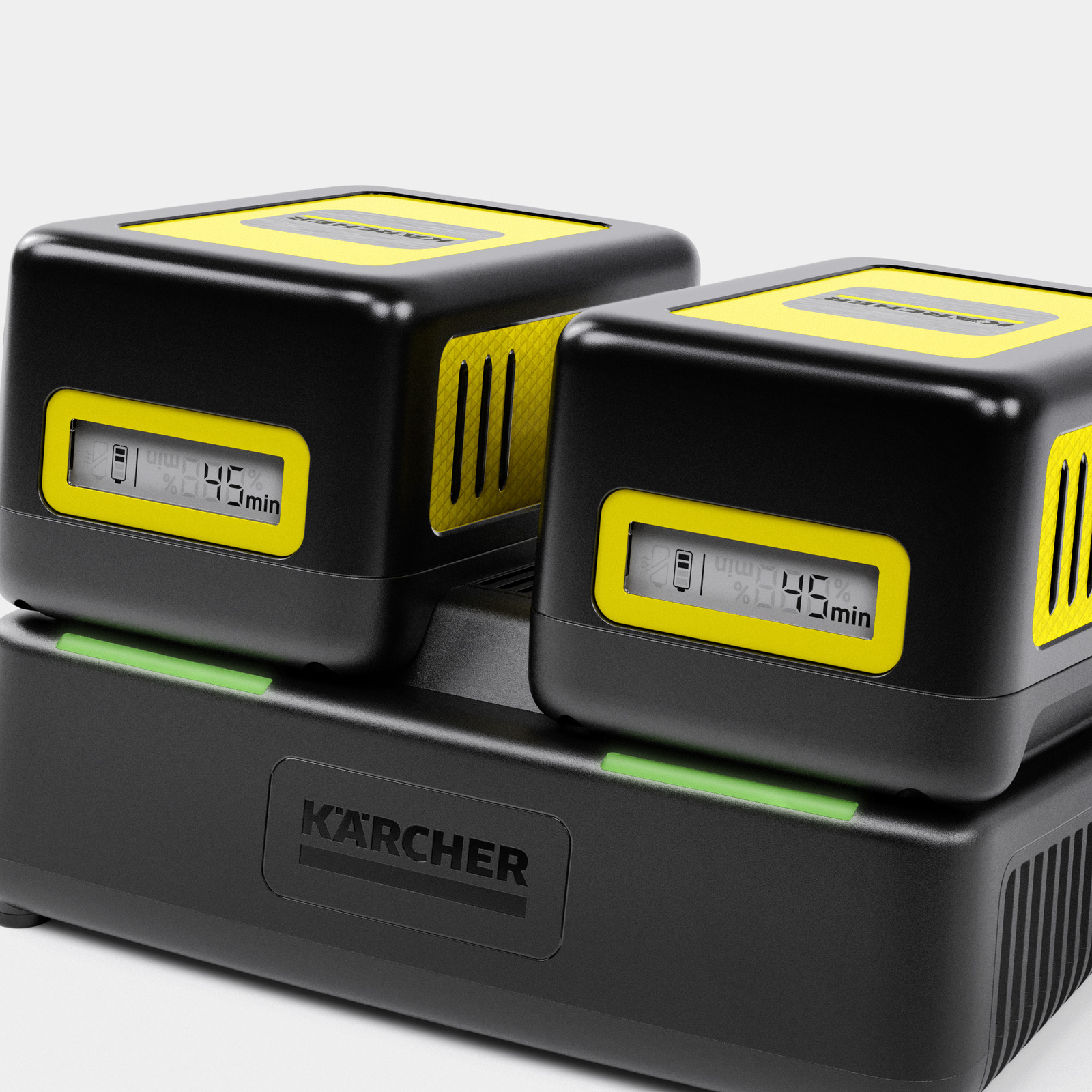 Due batterie Kärcher nere con accenti gialli in carica su una stazione.