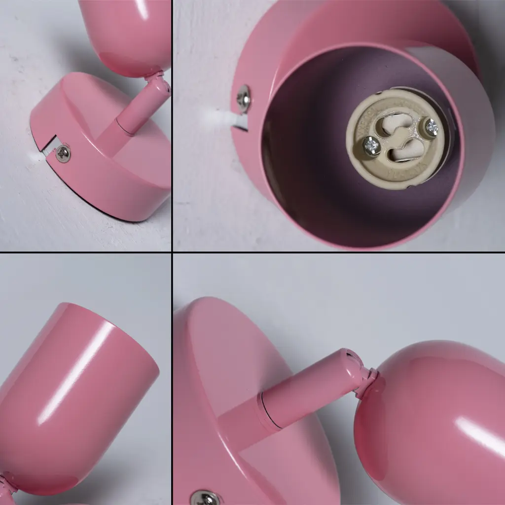 Base de lámpara rosa con brazo y pantalla ajustables, montada en pared.