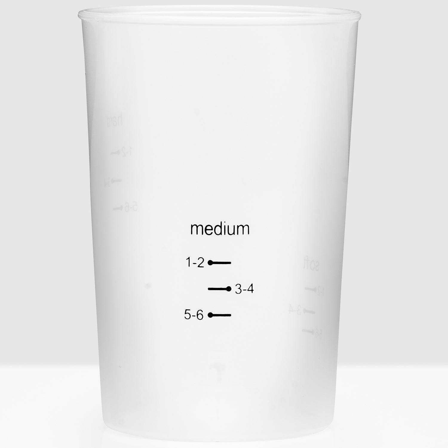 A white measuring cup with black markings and the word "medium".