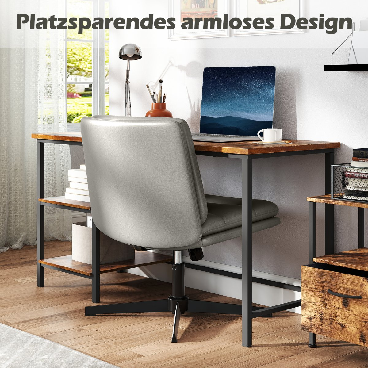 A desk with a laptop, mug, and lamp, next to a gray office chair.
