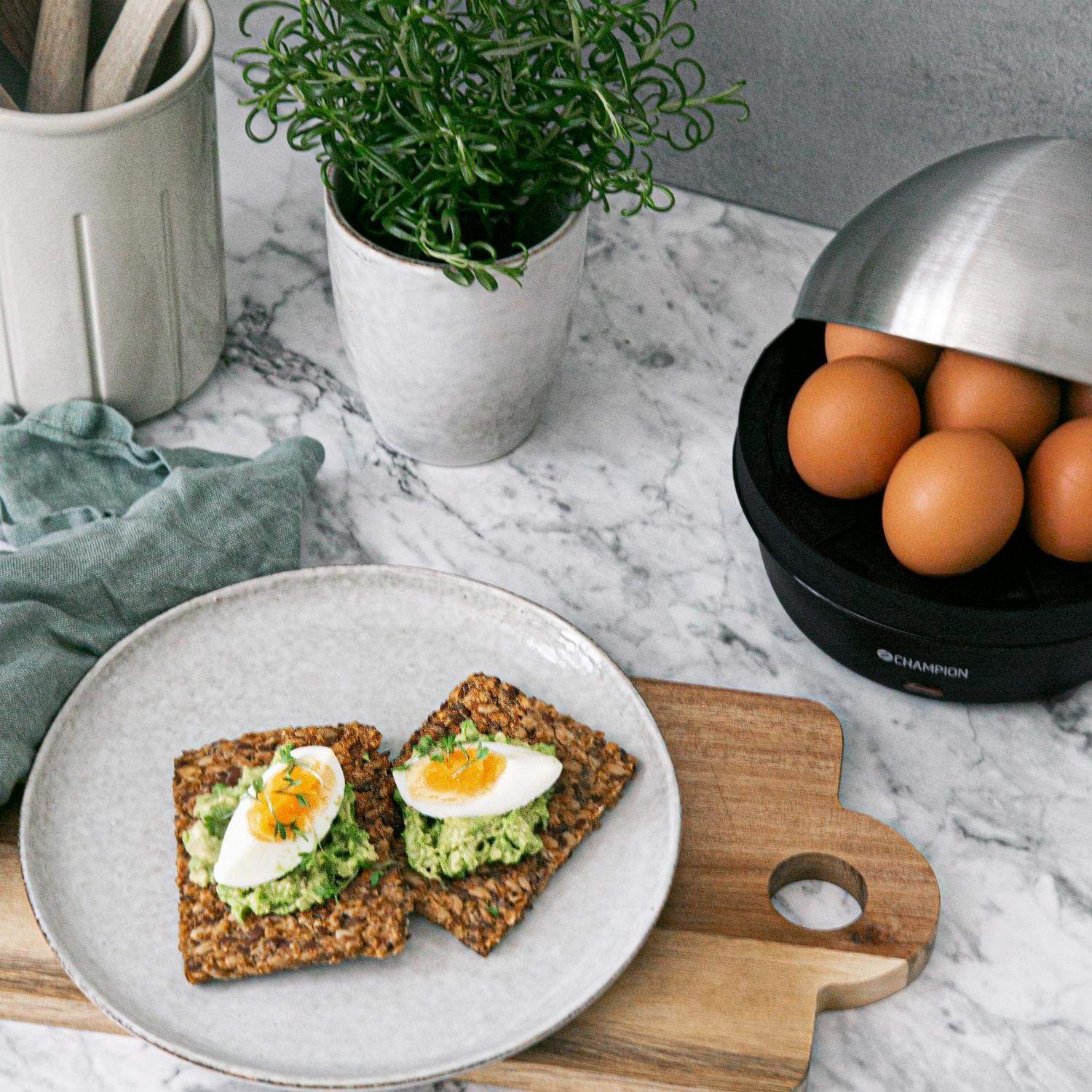 Two slices of whole grain bread topped with avocado and egg on a plate.