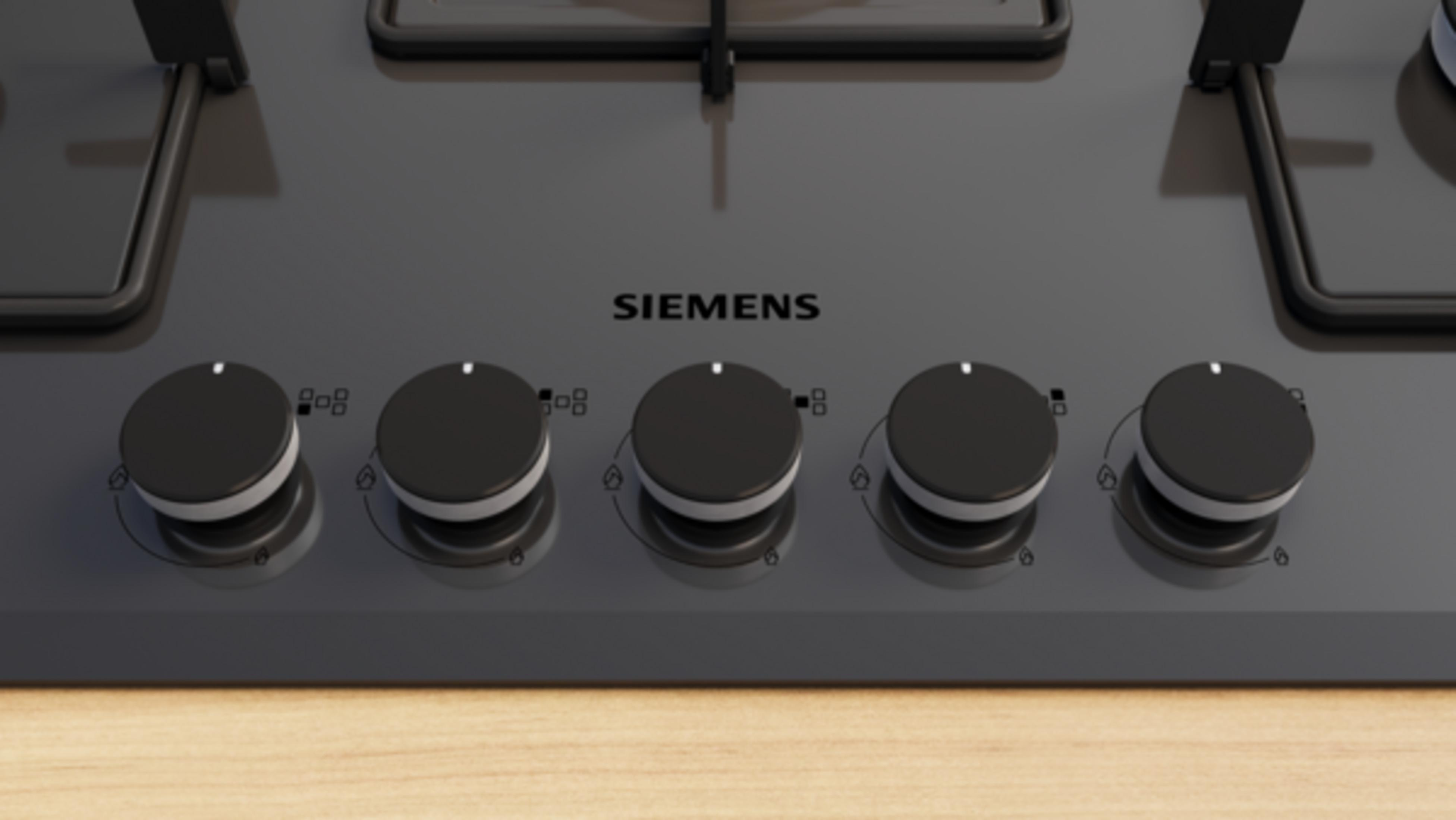 Metal çerçeveli, beş siyah kontrol düğmeli gri Siemens gazlı ocak.