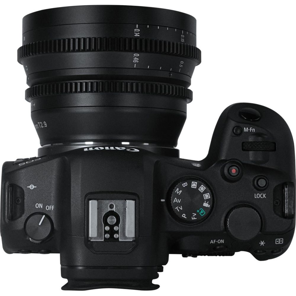 A black digital camera with lens, viewed from above.