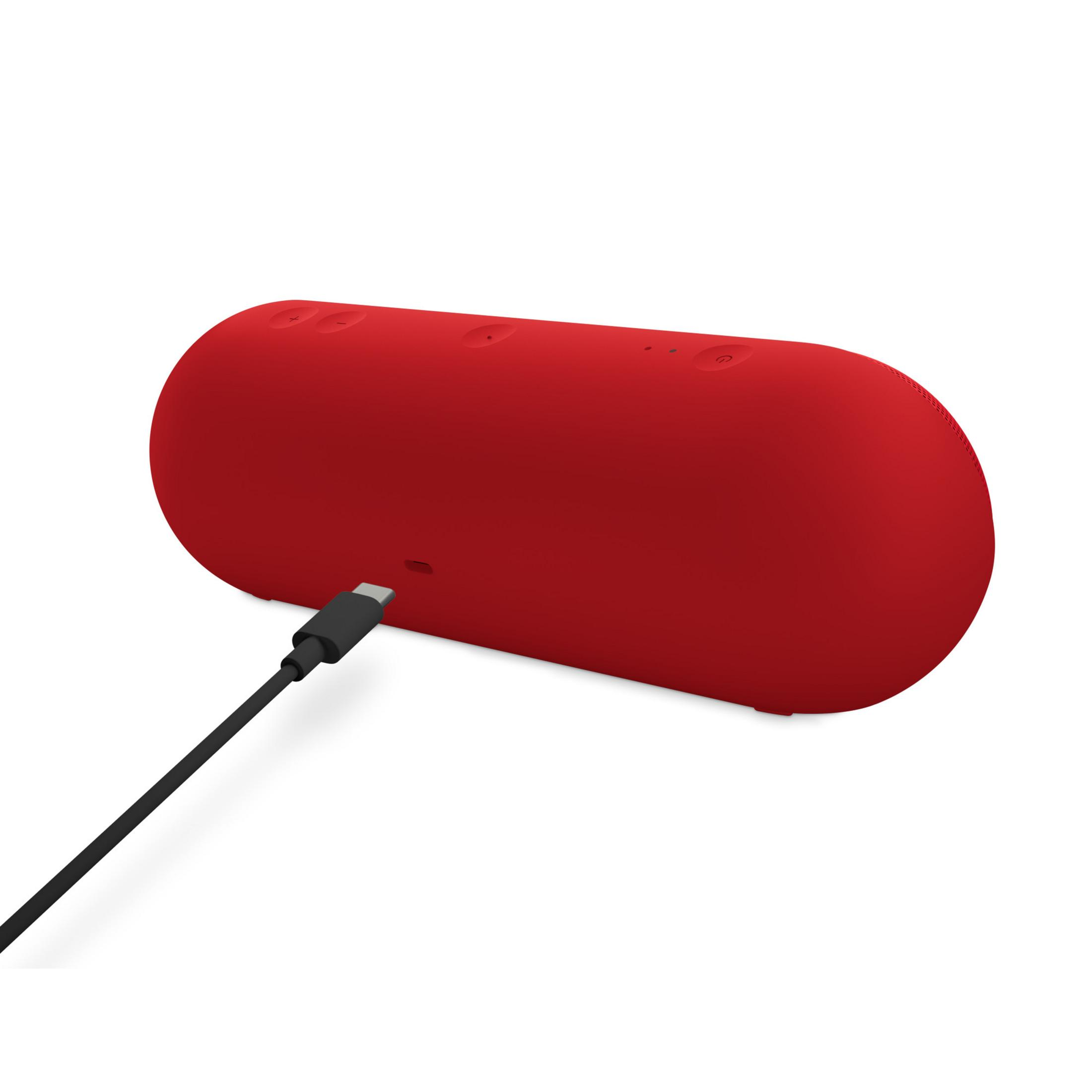 Un altoparlante rosso si sta caricando con un cavo USB-C nero.