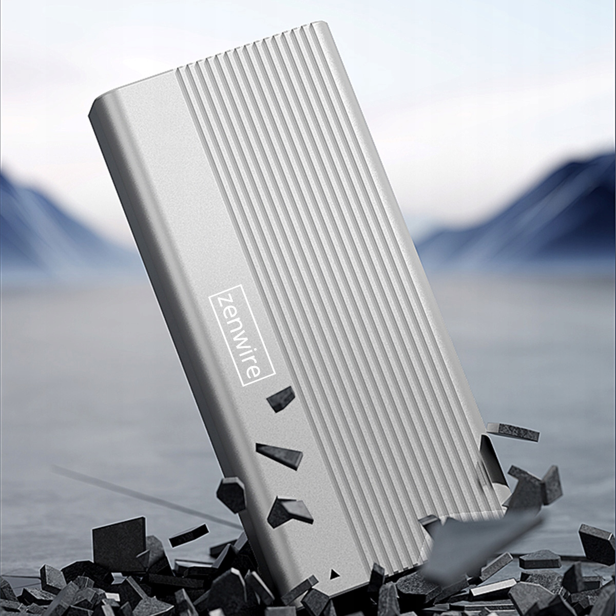 Srebrny dysk Zenwire wyłaniający się z połamanej skały.