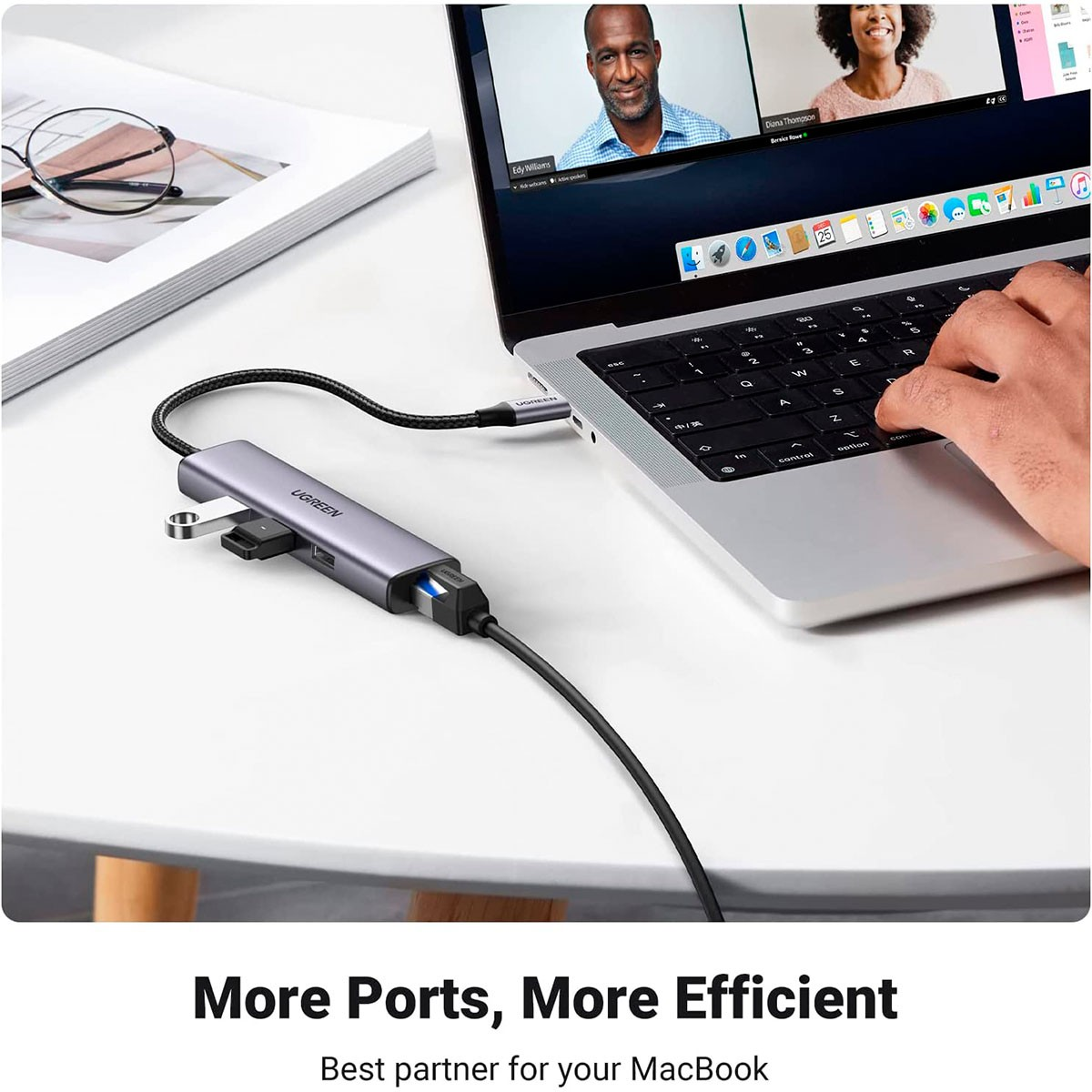 Laptop z podłączonym po bokach koncentratorem USB-C, pokazujący spotkanie wideo.