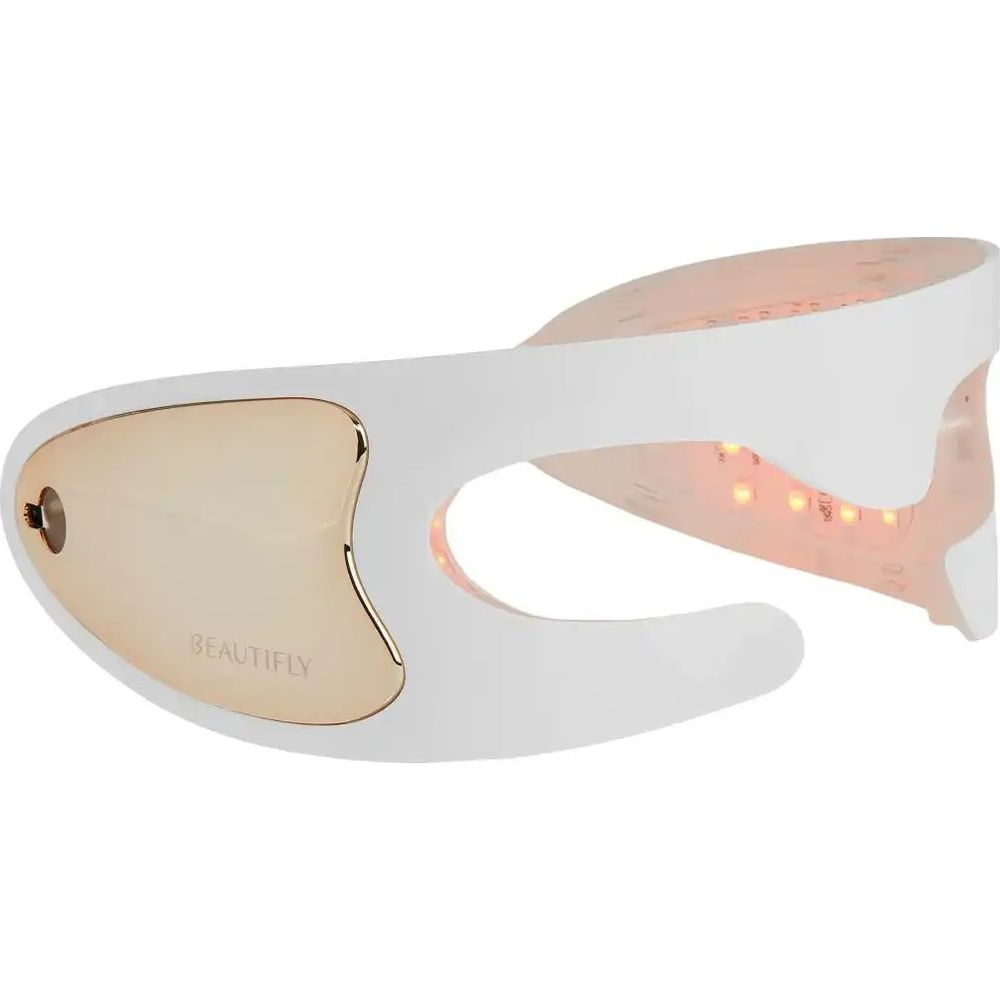 Ein weißes Schönheitsgerät mit Golddetails und roten LEDs.