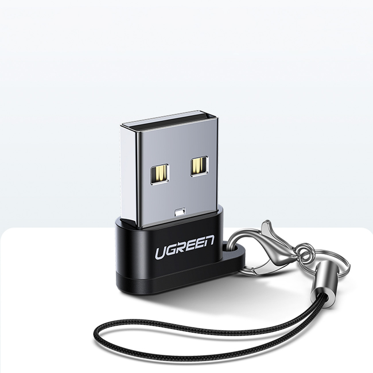 Siyah UGREEN USB adaptör, kordon ve karabina klipsli.