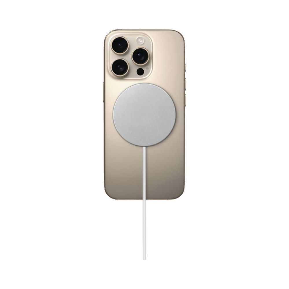 Un iPhone doré avec chargeur MagSafe et câble sur fond blanc.