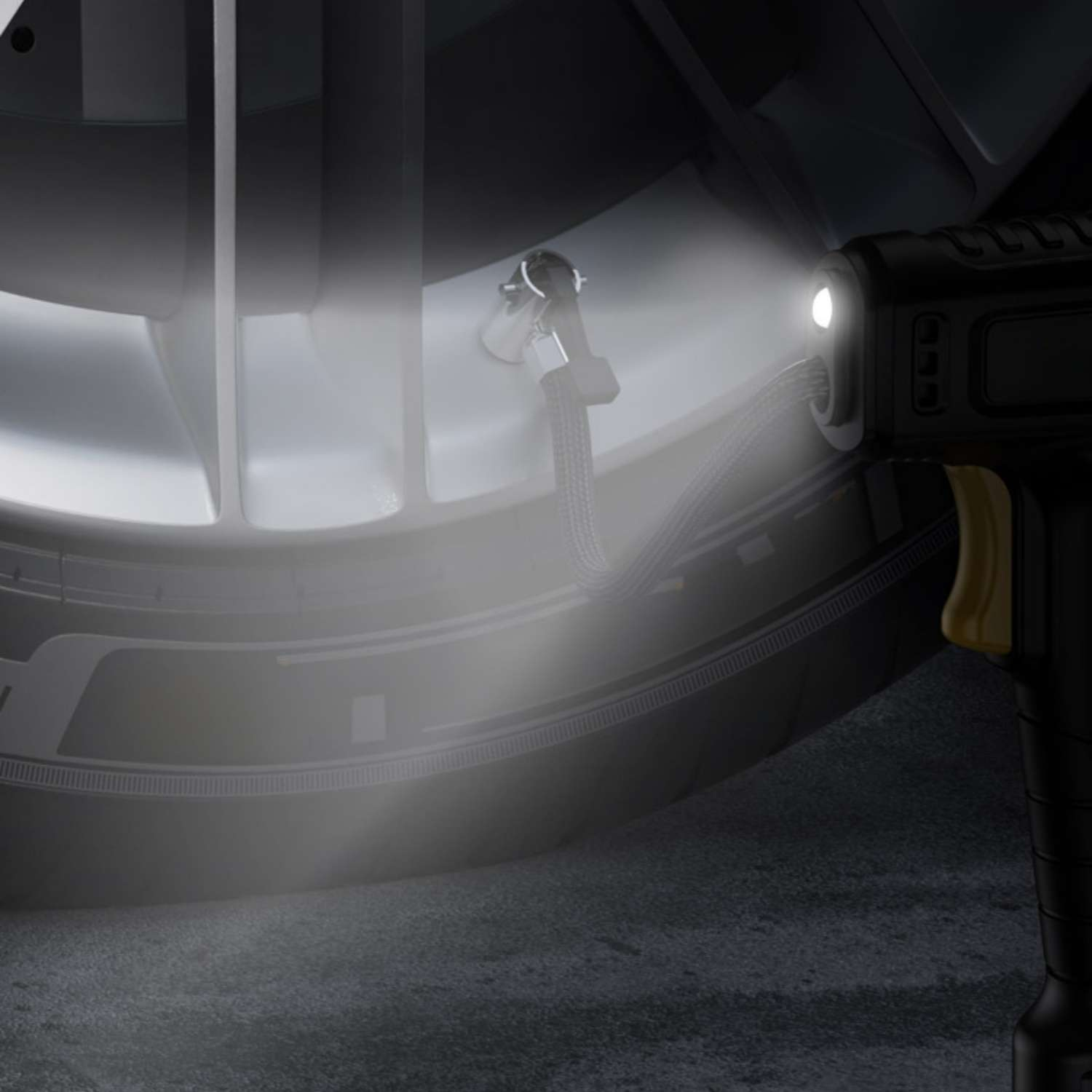 Ein schwarzer Reifenfüller mit LED-Licht beleuchtet ein Ventil am Auto.