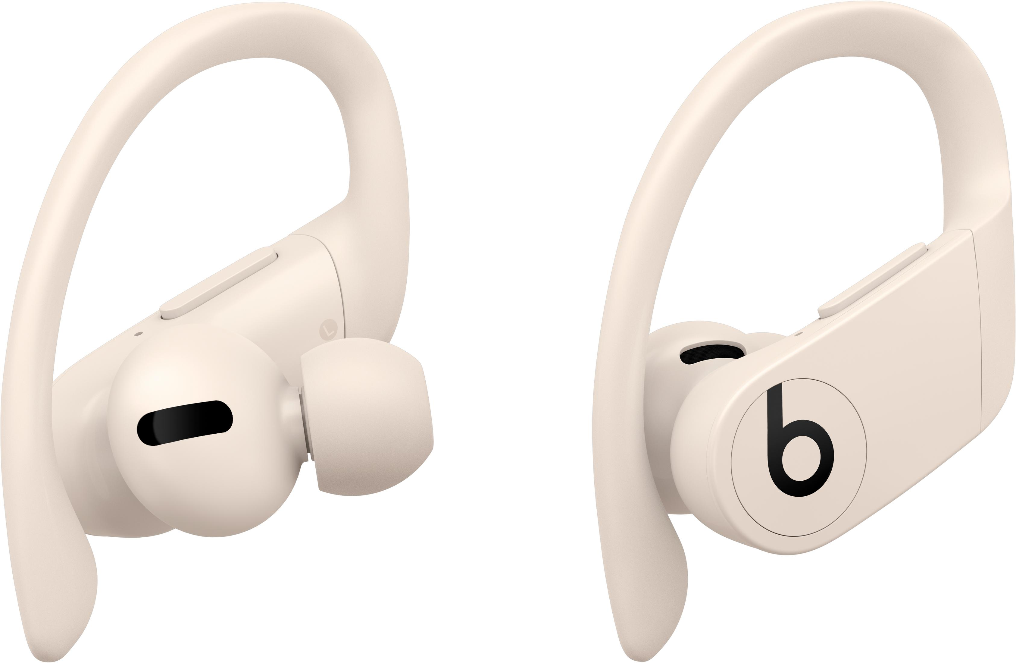 Two beige wireless earbuds with black logo, on a white background.