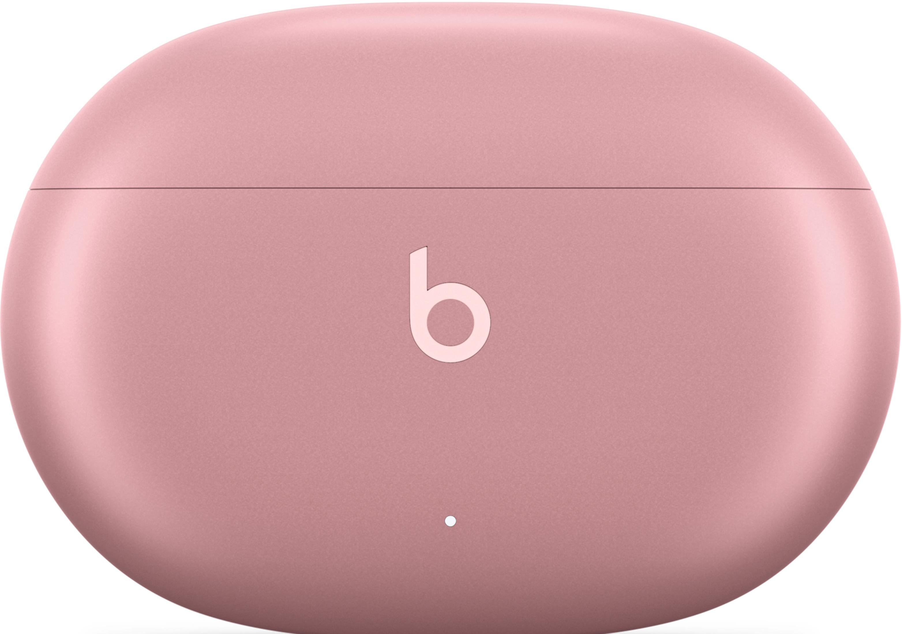 Różowe etui ładujące do słuchawek dousznych z logo "b".