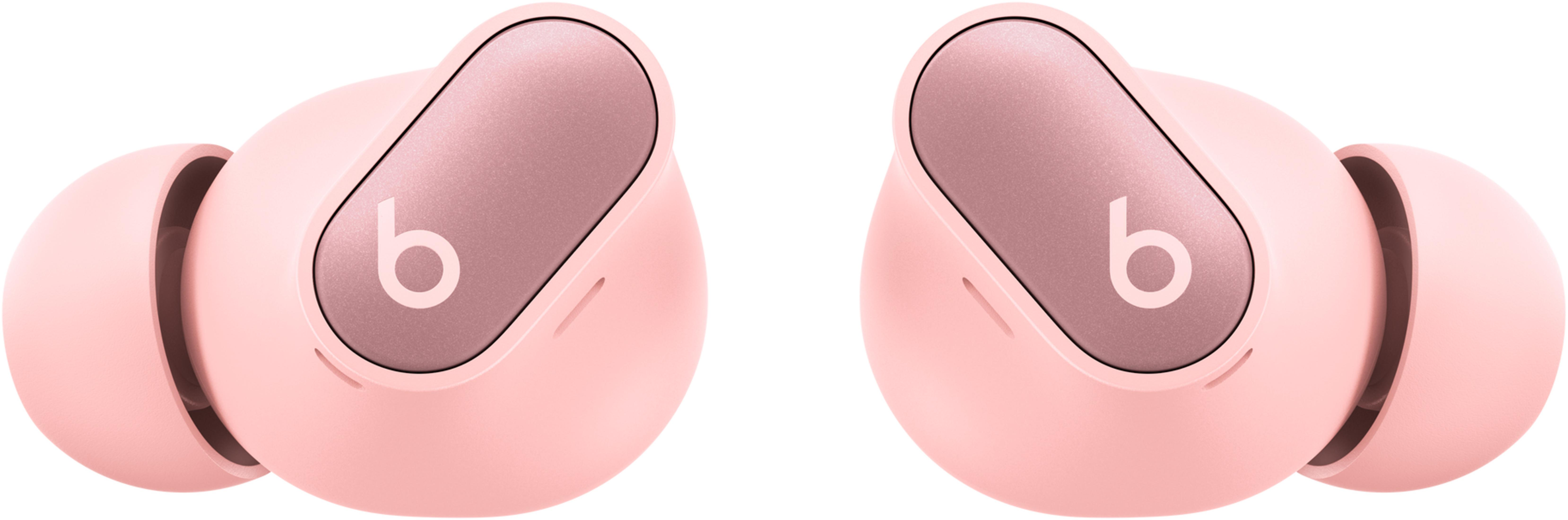 Dwa różowe słuchawki bezprzewodowe ze srebrnym akcentem i logo „b”.