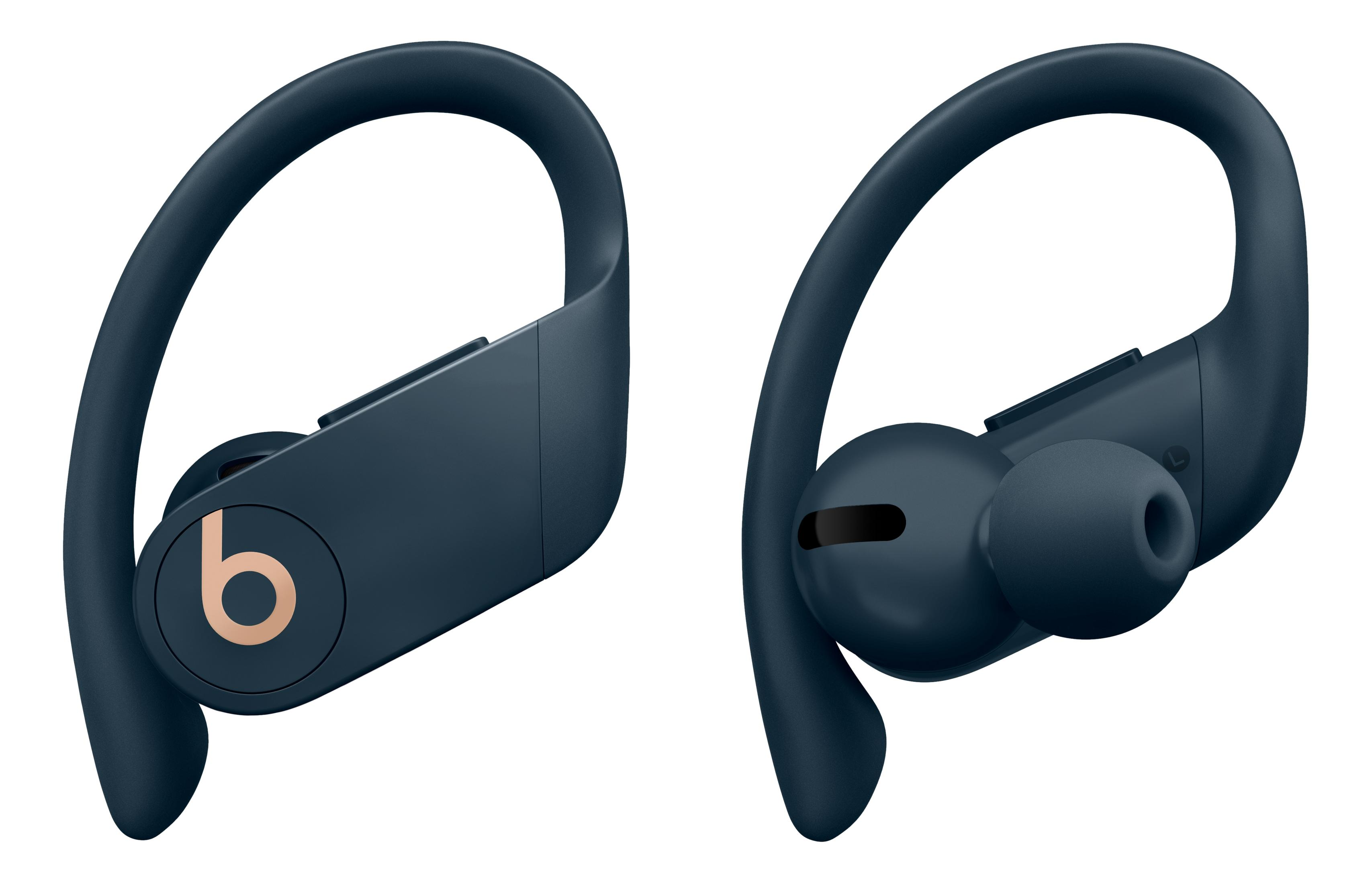 Two navy blue wireless earbuds with ear hooks and a gold Beats logo.