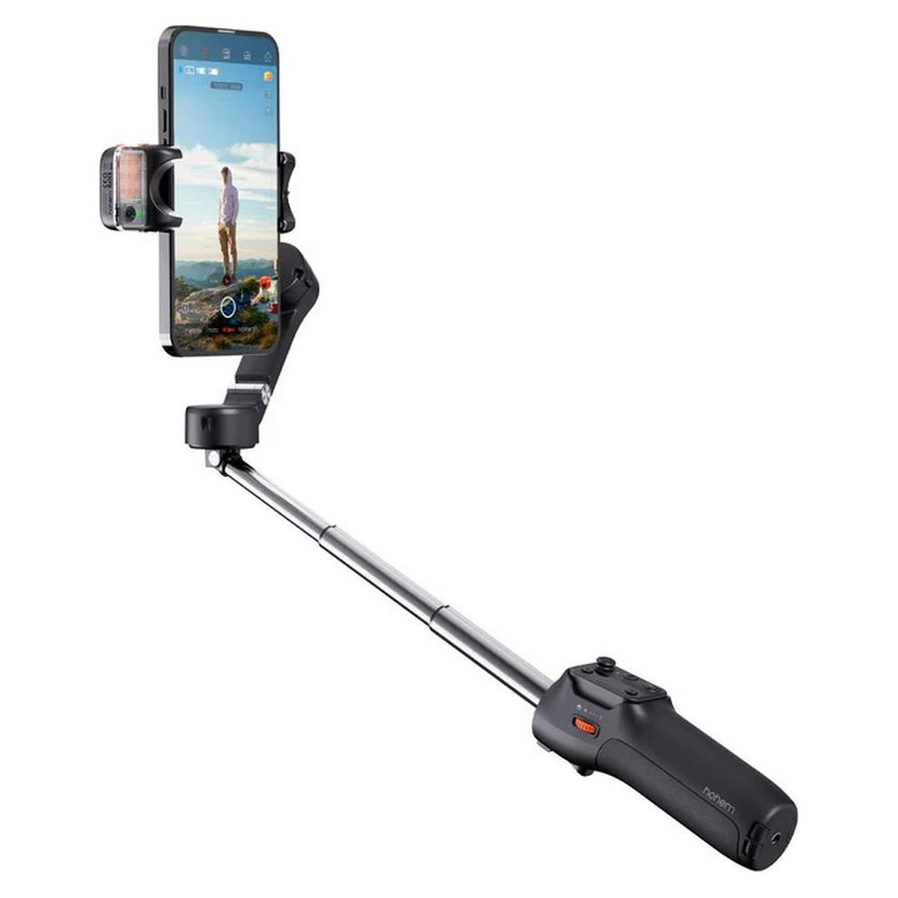 Stabilizator gimbala trzyma smartfon. Kijak jest wysuwany.