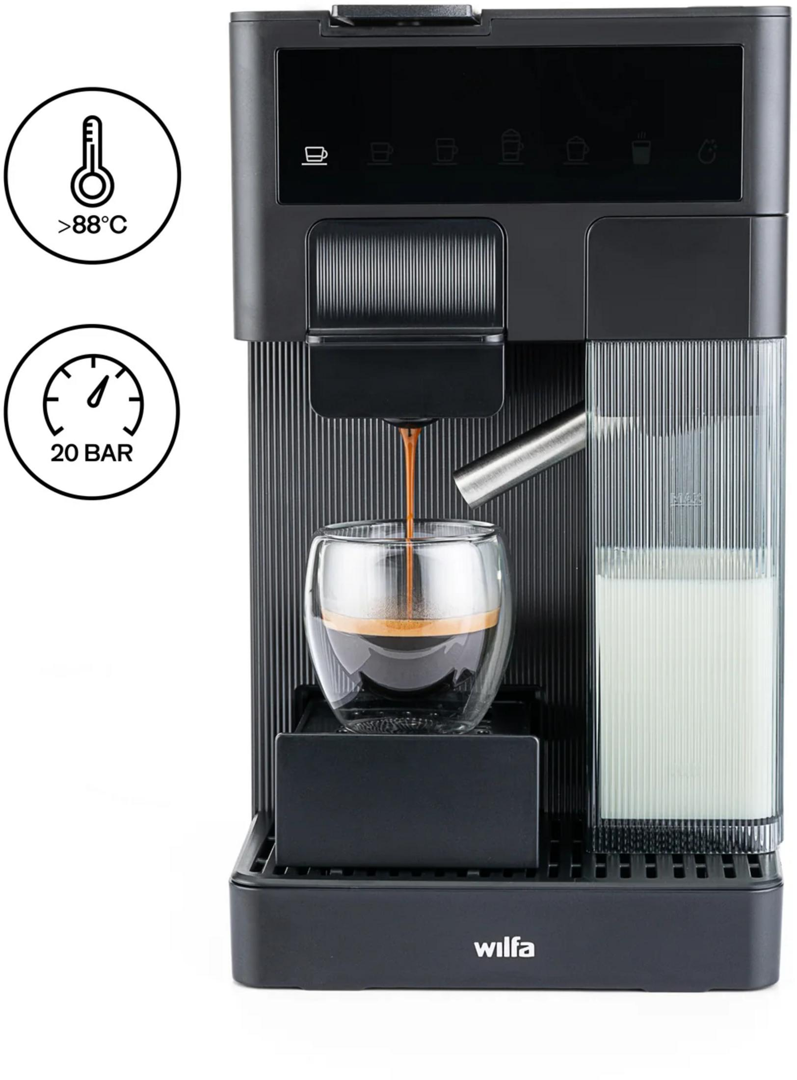 Cafetera preparando espresso en un vaso. Contenedor de leche al lado.