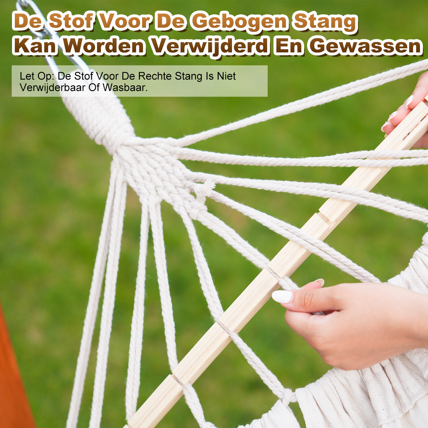 A hand with white nail polish adjusts ropes on a wooden bar of a hammock.